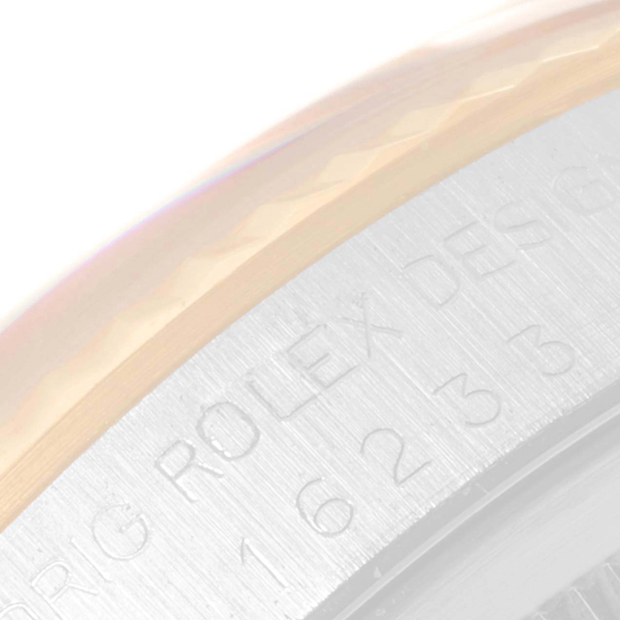 The image shows a close-up of the bezel and part of the casing with engraved text on the Rolex Datejust 16233 Men's Steel and Gold (two tone) Champagne Dial 16233 Men's Steel and Gold (two tone) Champagne Dial watch.