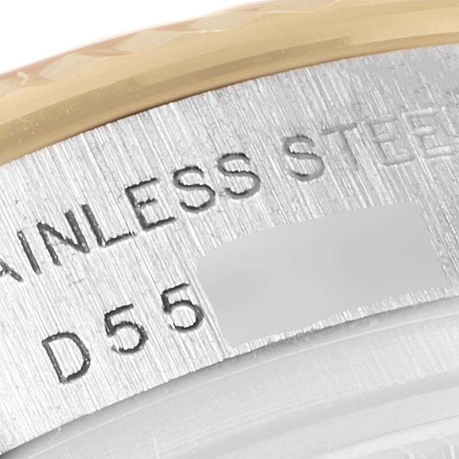 The image shows a close-up angle of the engraved serial number on the case back of a Rolex Datejust 179173 Women's Steel and Gold (two tone) Pink Dial 179173 Women's Steel and Gold (two tone) Pink Dial watch.