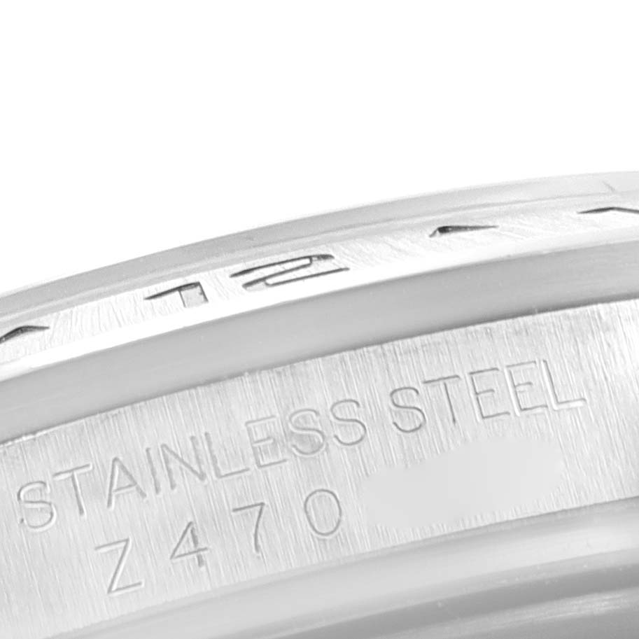 This image shows a close-up angle of the stainless steel bezel of the Rolex Explorer 16570 Men's Stainless Steel White Dial 16570 Men's Stainless Steel White Dial model.