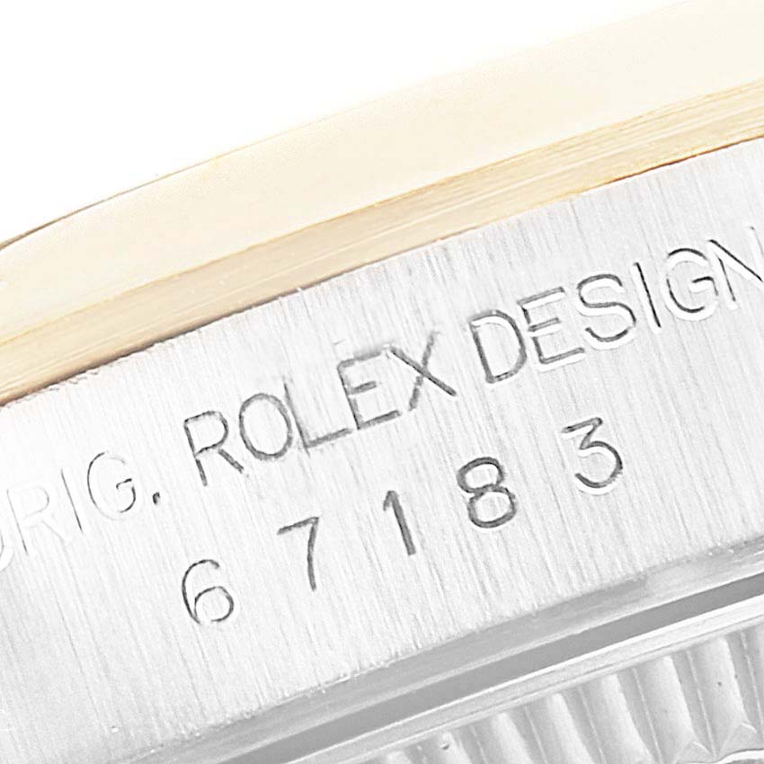 A close-up of the side of the Rolex Oyster Perpetual 67183 Women's Steel and Gold (two tone) Grey Dial 67183 Women's Steel and Gold (two tone) Grey Dial watch, showing the text "ROLEX DESIGN" and the model number.