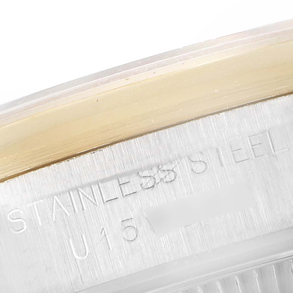 The image shows a close-up of the case back of a Rolex Oyster Perpetual 67183 Women's Steel and Gold (two tone) Grey Dial 67183 Women's Steel and Gold (two tone) Grey Dial watch, focusing on the engraved text.