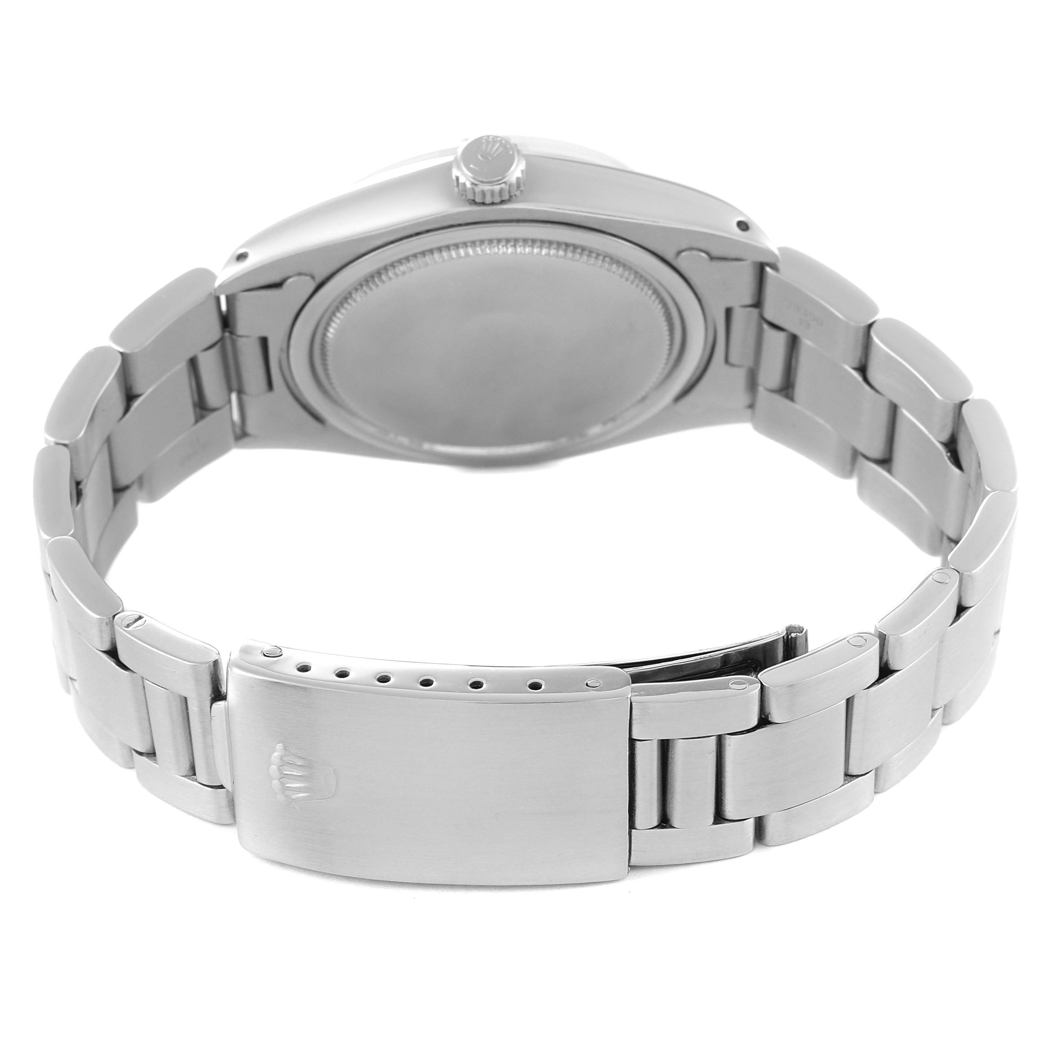 This image shows the back view of a Vintage Collection Rolex watch, highlighting its metal bracelet and clasp.