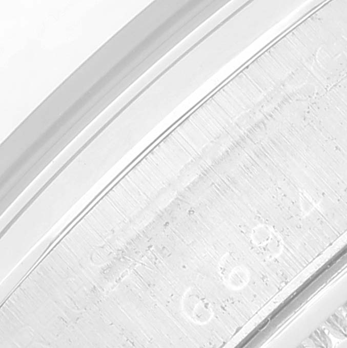 This close-up image focuses on the engraved details of the bezel and edge of a Rolex Vintage Collection 6694 Men's Stainless Steel Black Dial 6694 Men's Stainless Steel Black Dial model watch.