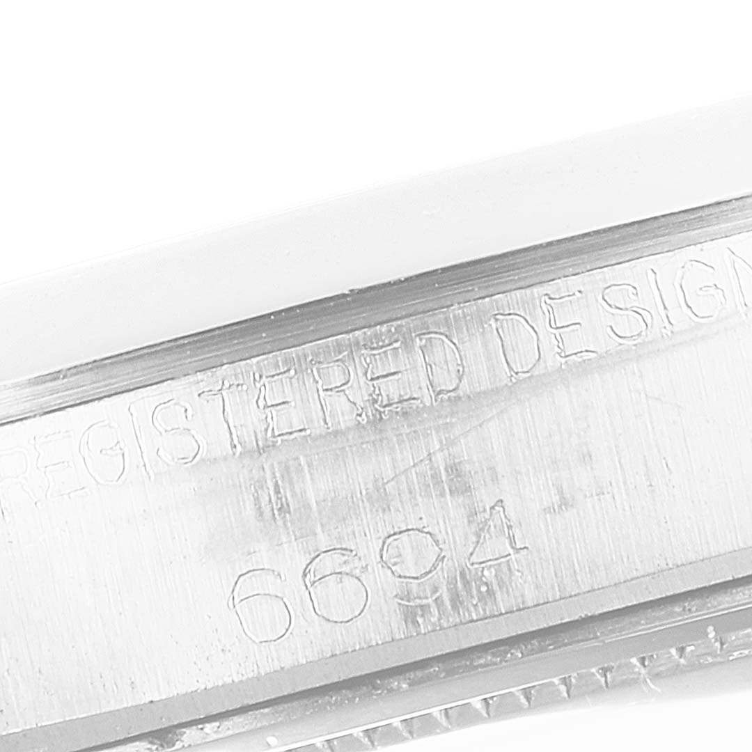 This close-up image of a Rolex Vintage Collection 6694 Men
s Stainless Steel Silver Dial 6694 Men
s Stainless Steel Silver Dial model shows the engraving on the watch
s case side.