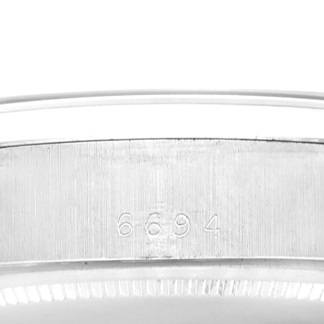 The image shows a close-up of the side casing of the Rolex Vintage Collection 6694 Men
s Stainless Steel Silver Dial 6694 Men
s Stainless Steel Silver Dial model 6694, displaying the serial number.