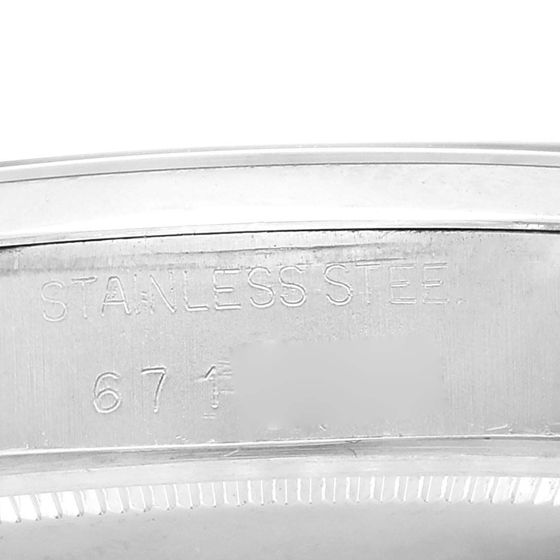 This is a close-up image of the case back edge showing the engraving "STAINLESS STEEL" of the Rolex Vintage Collection 6694 Men
s Stainless Steel Silver Dial 6694 Men
s Stainless Steel Silver Dial model.