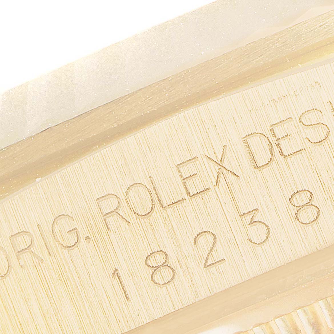 The image shows a close-up of the engraved inner bezel with details on a Rolex President 18238 Men
s Yellow Gold Champagne Dial 18238 Men
s Yellow Gold Champagne Dial model watch.