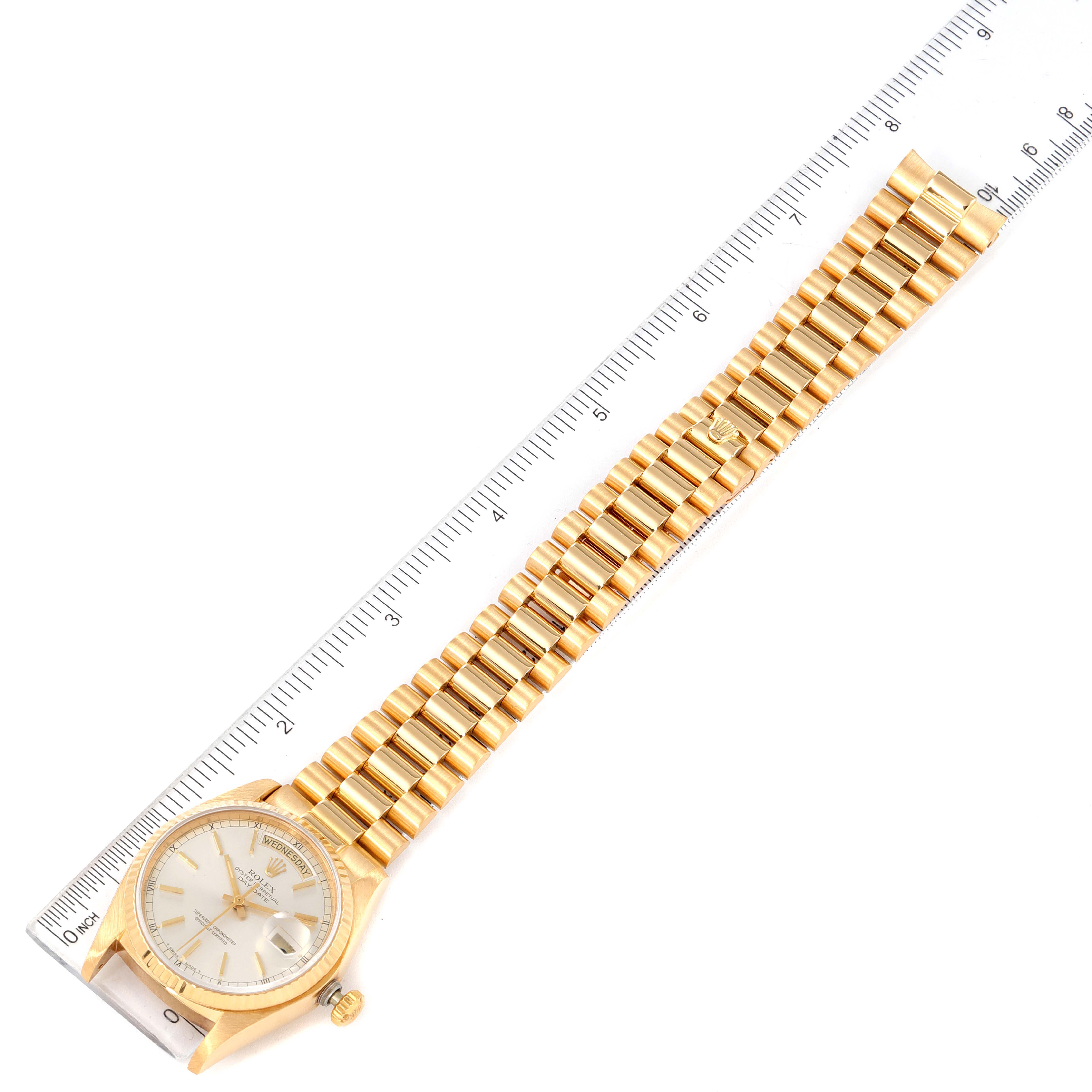 The image shows a Rolex President 18038 Men
s Yellow Gold Silver Dial 18038 Men
s Yellow Gold Silver Dial model watch from a top-down angle, including the face, bracelet, and part of the crown.