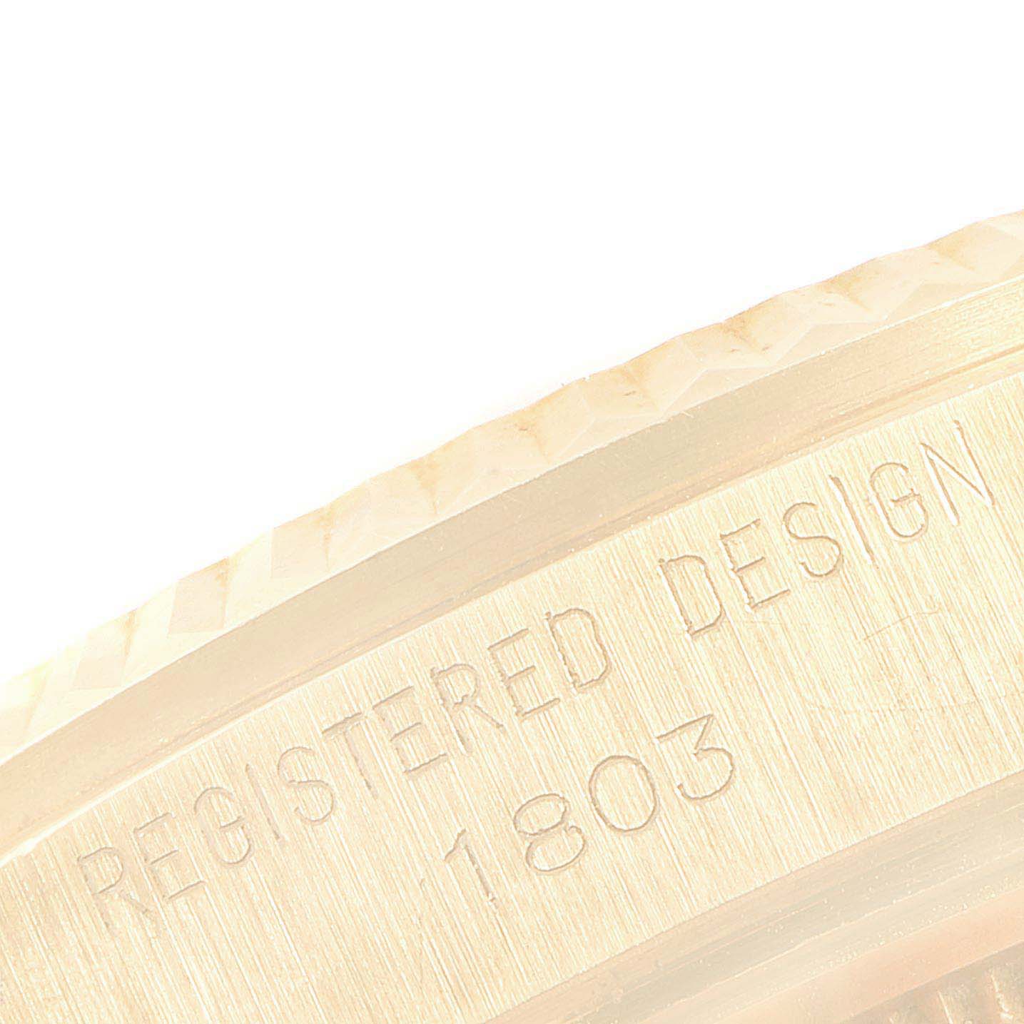 The image shows a close-up angle of the side bezel and casing of a Rolex Vintage Collection 1803 Men's Yellow Gold Champagne Dial 1803 Men's Yellow Gold Champagne Dial model, highlighting the etched "REGISTERED DESIGN 1803" inscription.