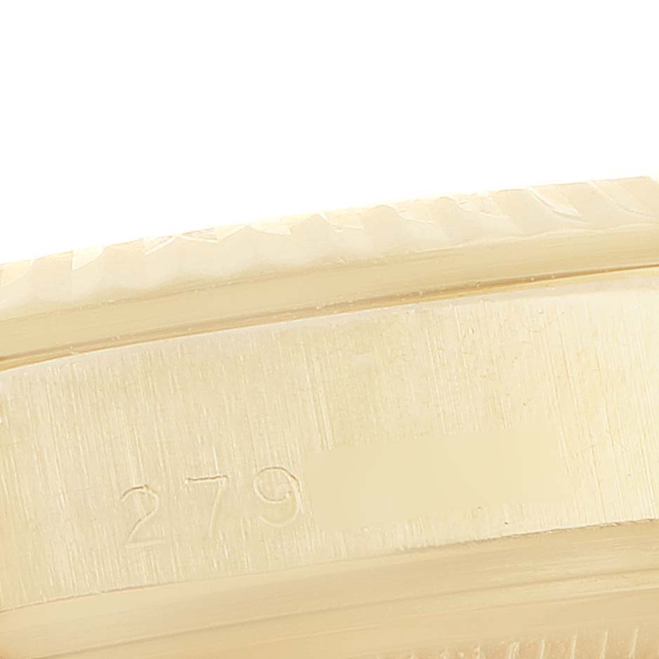 This close-up image shows the engraved side of the bezel and part of the case of a Rolex Vintage Collection 1803 Men's Yellow Gold Champagne Dial 1803 Men's Yellow Gold Champagne Dial model watch.