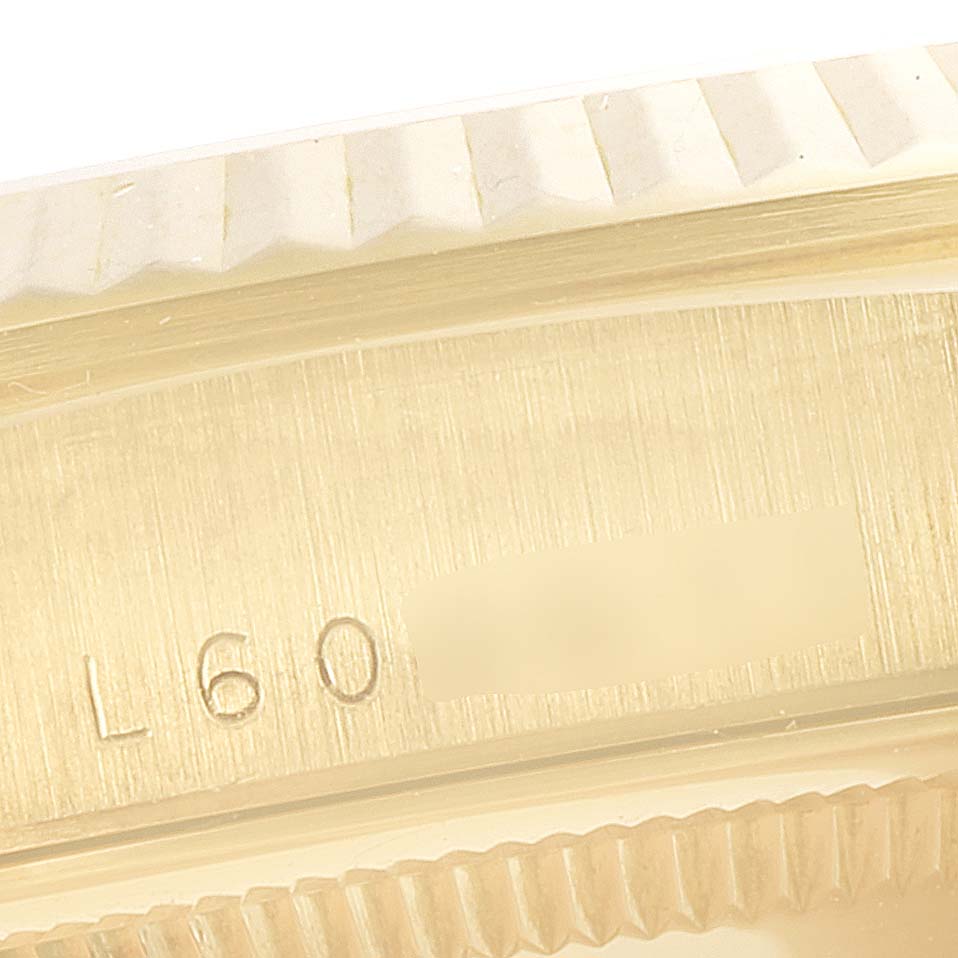 This image shows a close-up of the bezel and case side of a Rolex President 18238 Men's Yellow Gold Champagne Dial 18238 Men's Yellow Gold Champagne Dial model watch, highlighting part of the serial number.
