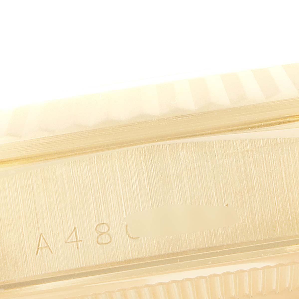 This image shows a close-up angle of the serial number on the case of a Rolex President 18238 Men's Yellow Gold Champagne Dial 18238 Men's Yellow Gold Champagne Dial model watch.