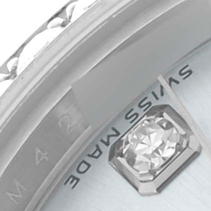 The image shows a close-up angle of the Rolex President 179136 Women's Platinum Blue Dial 179136 Women's Platinum Blue Dial model, highlighting the bezel, a diamond marker, and part of the dial with text.