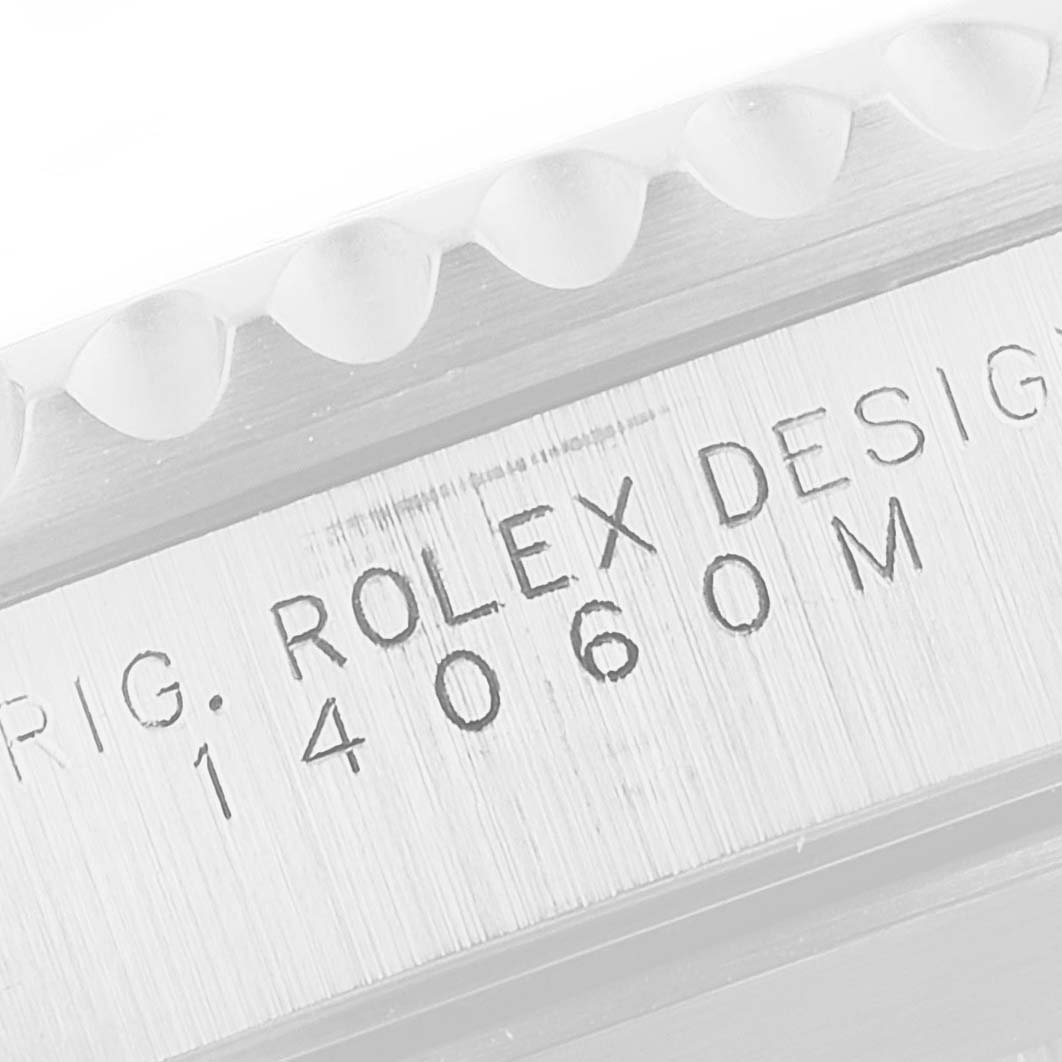 The image shows an engraved side view of a Rolex Submariner 14060 Men
s Stainless Steel Black Dial 14060 Men
s Stainless Steel Black Dial watch with its model number 14060M.