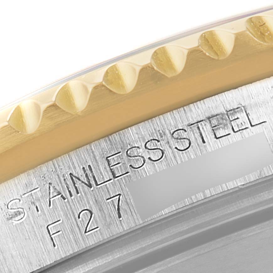 The image shows a close-up of the case back and part of the bezel of a Rolex Submariner 16613 Men's Steel and Gold (two tone) Blue Dial 16613 Men's Steel and Gold (two tone) Blue Dial, highlighting the stainless steel and engraving.