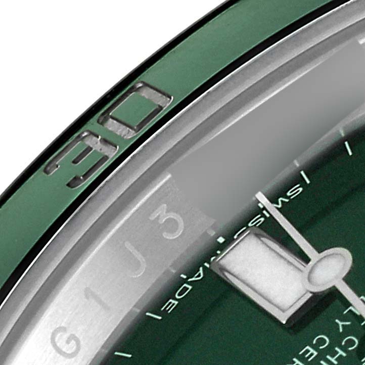 Close-up of the Rolex Submariner 116610LV Men
s Stainless Steel Green Dial 116610LV Men
s Stainless Steel Green Dial showing part of the bezel, dial, and minute hand, angled from the top right.