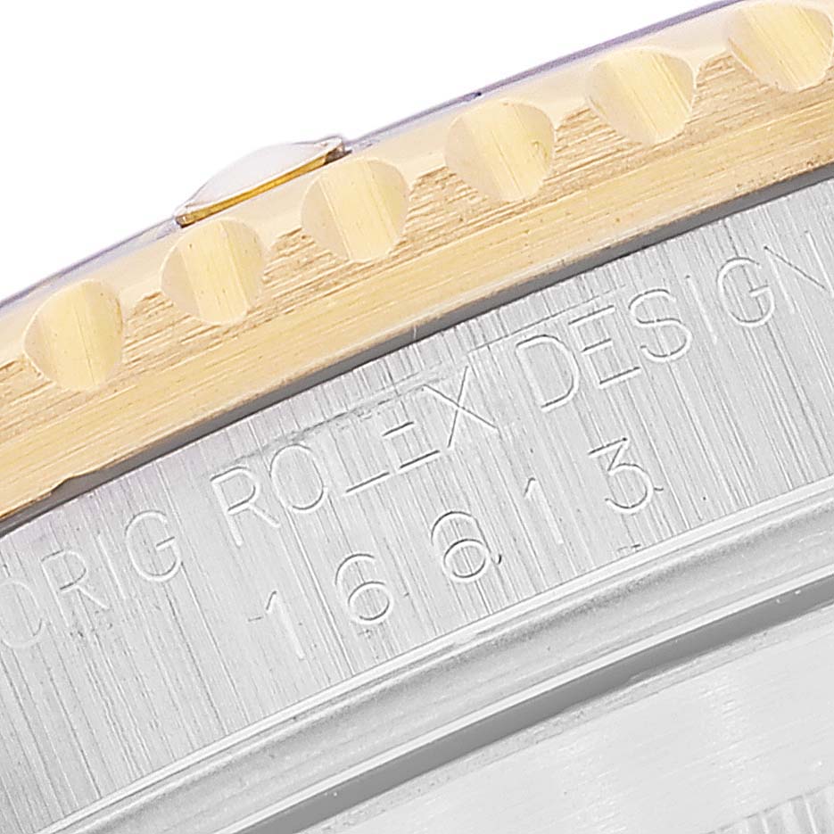 This image shows a close-up of the bezel and engraved model number of a Rolex Submariner 16613 Men's Steel and Gold (two tone) Grey Dial 16613 Men's Steel and Gold (two tone) Grey Dial watch.