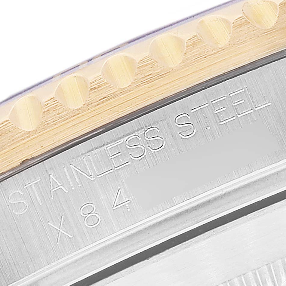 This image shows a close-up of the side of a Rolex Submariner 16613 Men's Steel and Gold (two tone) Grey Dial 16613 Men's Steel and Gold (two tone) Grey Dial watch, highlighting the stainless steel and the edge of the bezel.