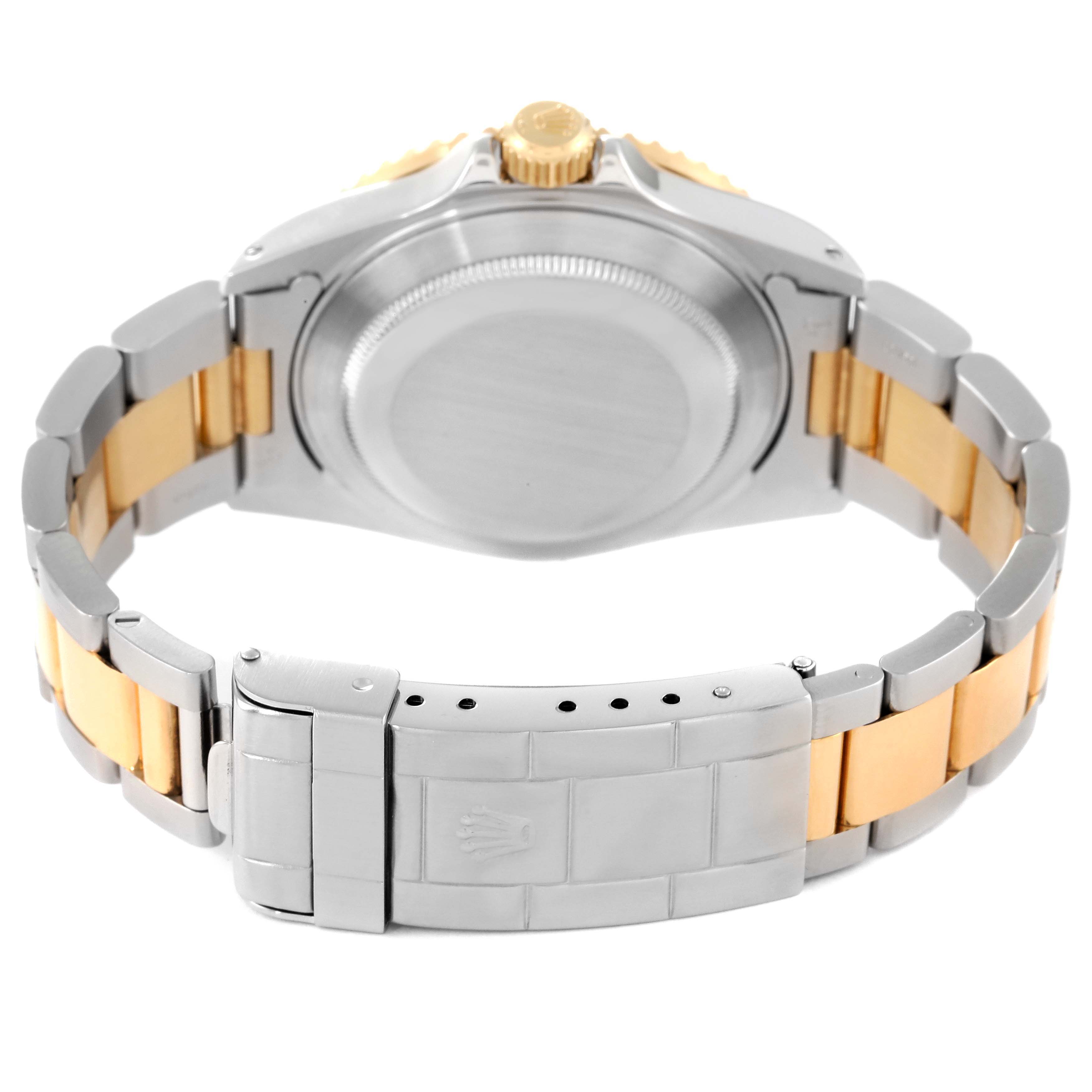 The image shows the back case and clasp of a Rolex Submariner 16613 Men's Steel and Gold (two tone) Grey Dial 16613 Men's Steel and Gold (two tone) Grey Dial watch, featuring a stainless steel and gold bracelet.