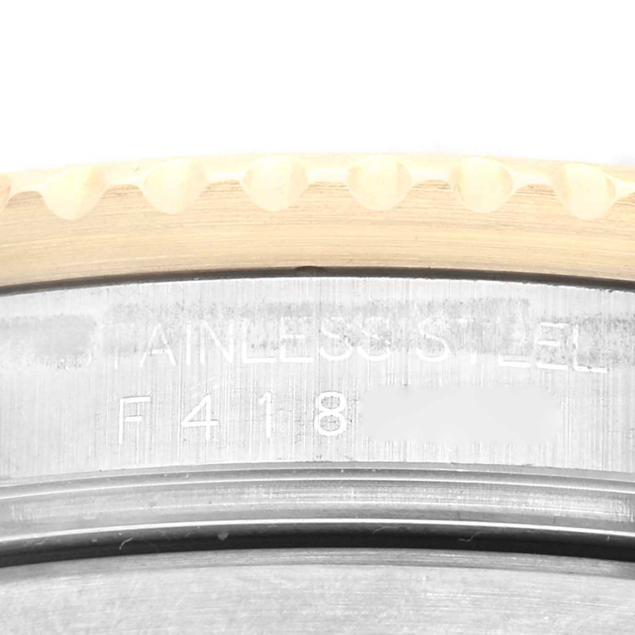 The image shows a close-up of the case back markings and the edge of the bezel of a Rolex Submariner 16613 Men's Steel and Gold (two tone) Black Dial 16613 Men's Steel and Gold (two tone) Black Dial watch.