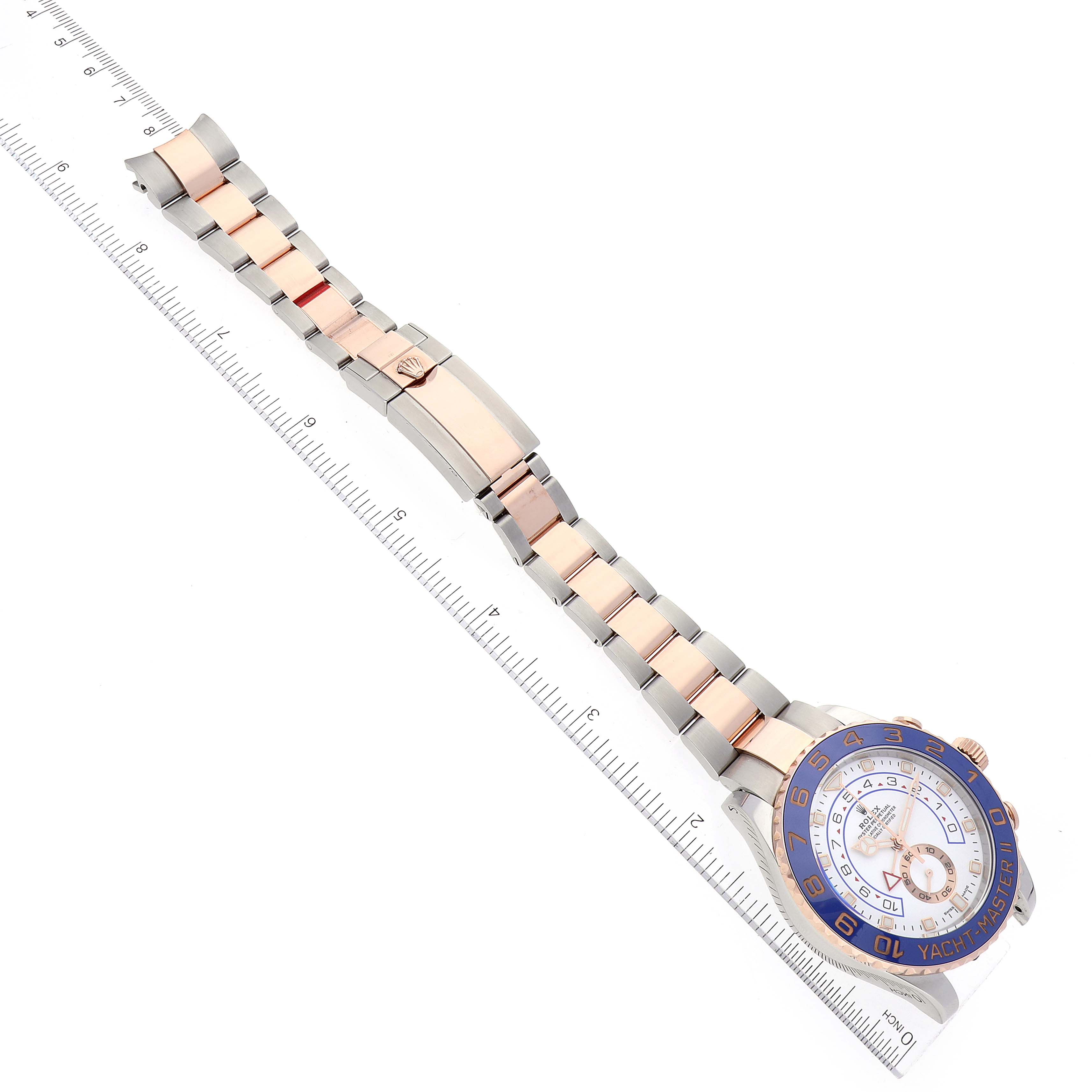 The Rolex Yacht-Master 116681 Men
s Steel and Gold (two tone) White Dial 116681 Men
s Steel and Gold (two tone) White Dial watch is shown from a top-down angle, displaying the face, bezel, bracelet, and deployment clasp.