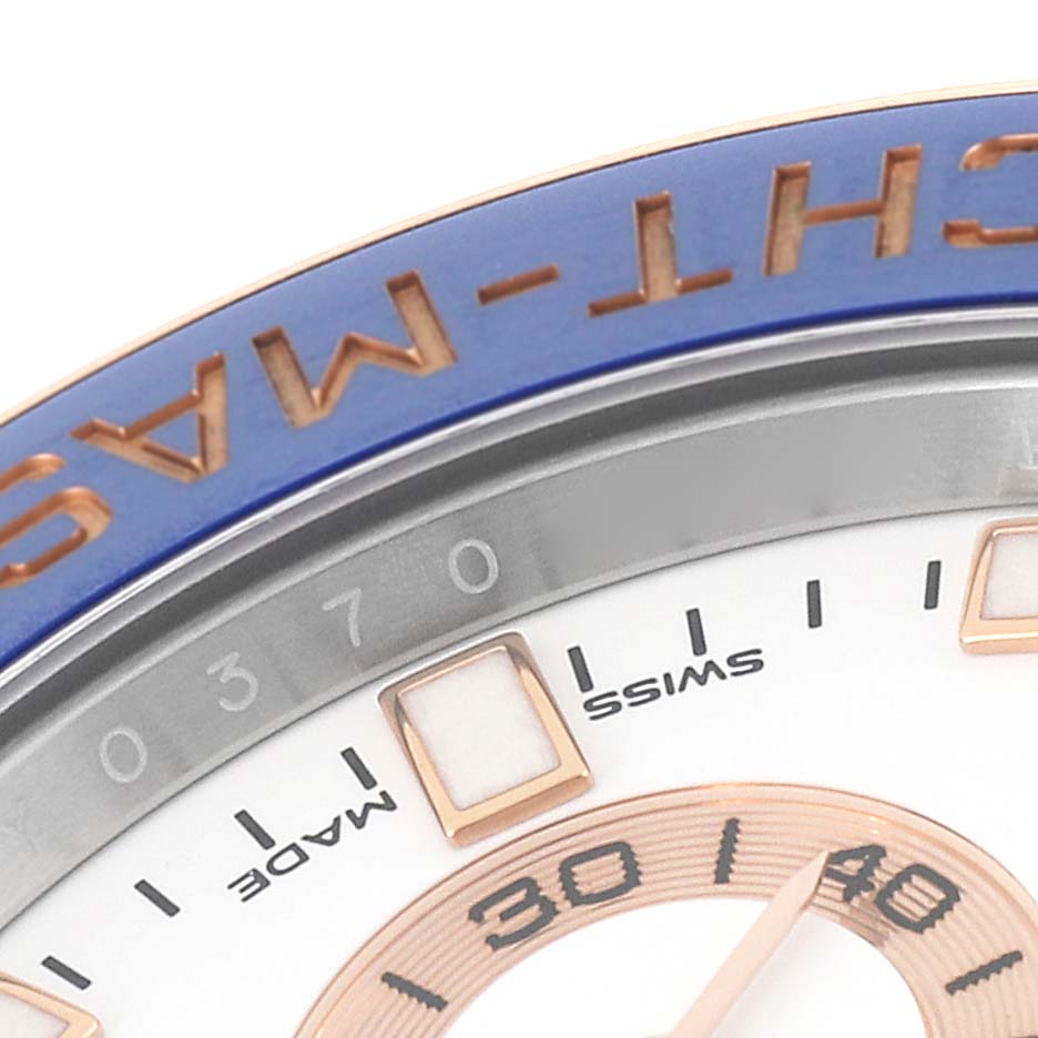 This close-up image of the Rolex Yacht-Master 116681 Men
s Steel and Gold (two tone) White Dial 116681 Men
s Steel and Gold (two tone) White Dial watch shows part of the bezel, dial, and hour markers.