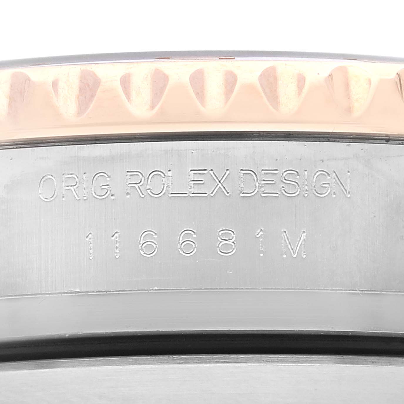 This close-up image shows part of the bezel and case back of a Rolex Yacht-Master 116681 Men
s Steel and Gold (two tone) White Dial 116681 Men
s Steel and Gold (two tone) White Dial watch, with model number 116681M engraved.