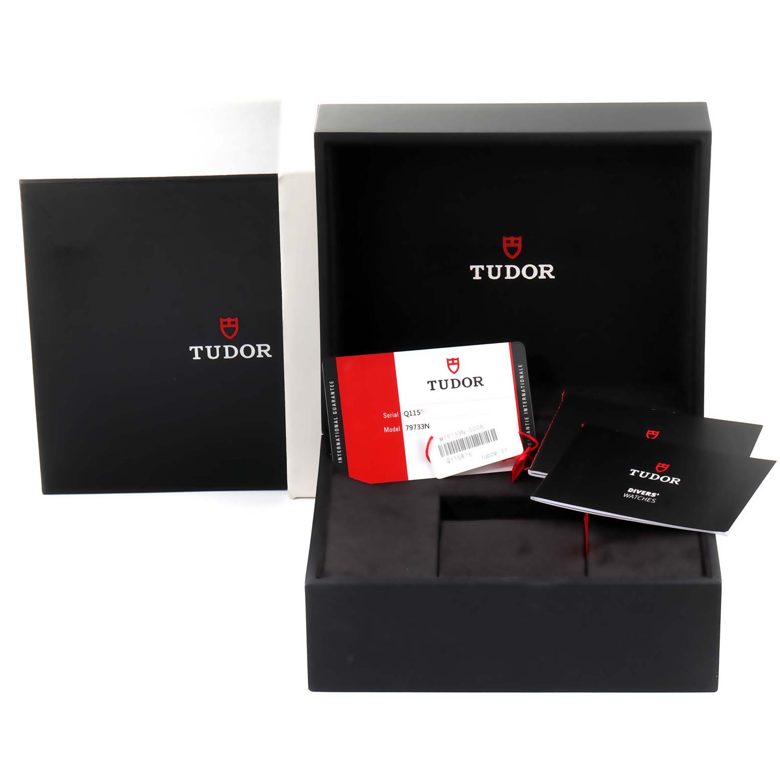 The image shows the packaging box, manual, and warranty card of the Tudor Heritage Black Bay 79733 Men's Steel and Gold (two tone) Black Dial 79733 Men's Steel and Gold (two tone) Black Dial watch. 