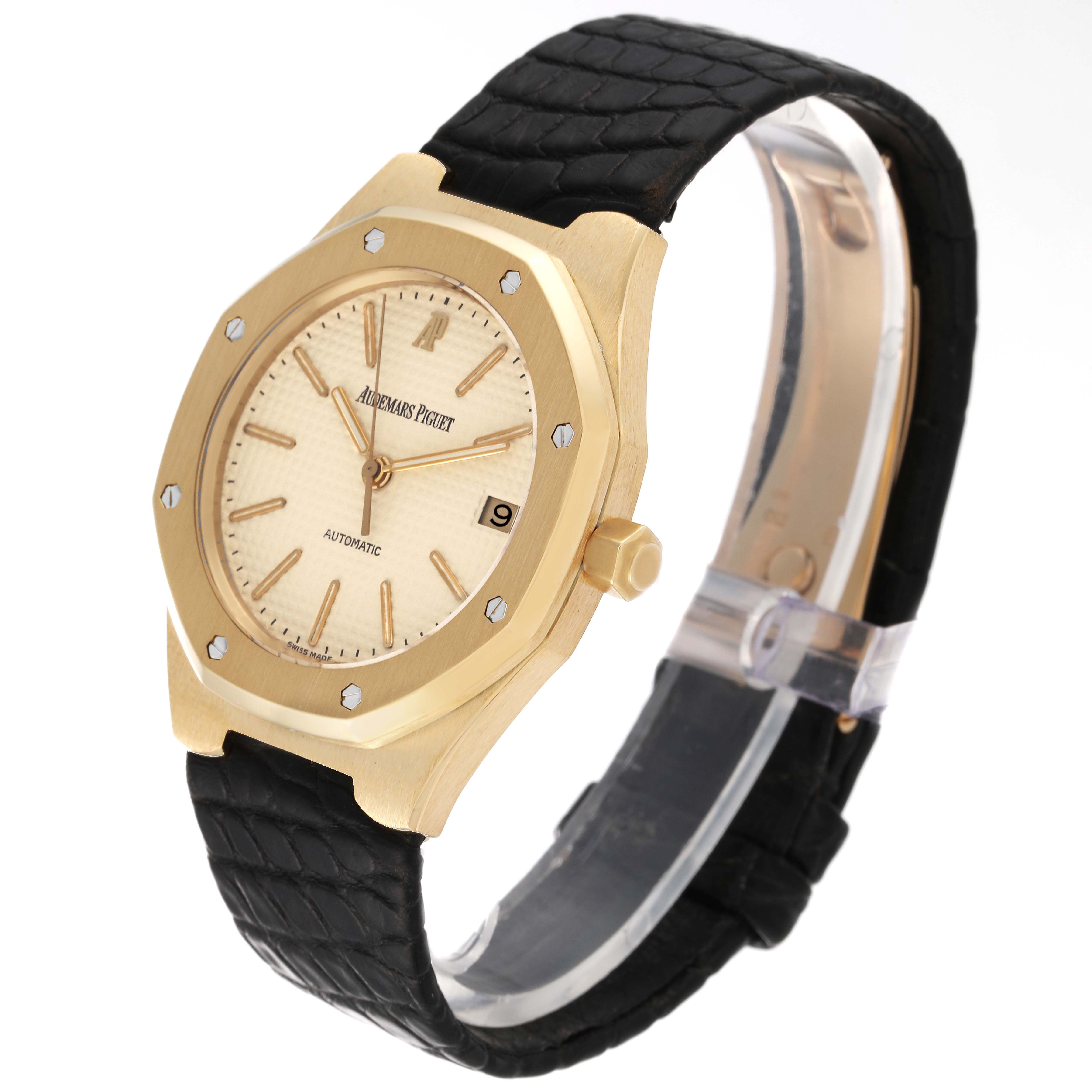 This is an Audemars Piguet Royal Oak 14808BA Men's Yellow Gold Beige Dial 14808BA Men's Yellow Gold Beige Dial watch shown at a side angle, displaying the face, bezel, crown, and strap.