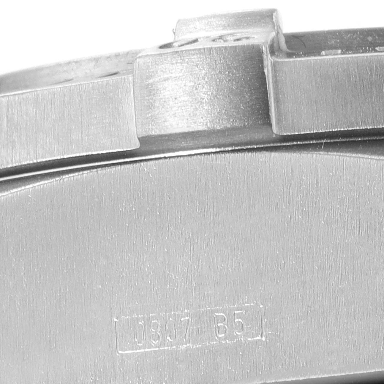 The image shows a close-up of the case back and part of the bezel of a Breitling Avenger E73360 Men's Titanium White Dial E73360 Men's Titanium White Dial watch.