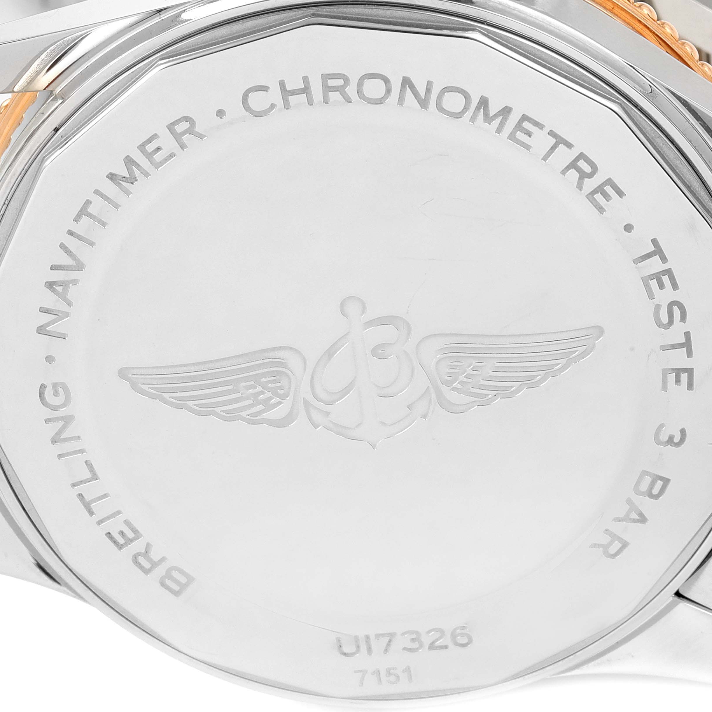 This image shows the back case of a Breitling Navitimer U17326 Men's Steel and Gold (two tone) Silver Dial U17326 Men's Steel and Gold (two tone) Silver Dial watch, featuring engraved text and logo.