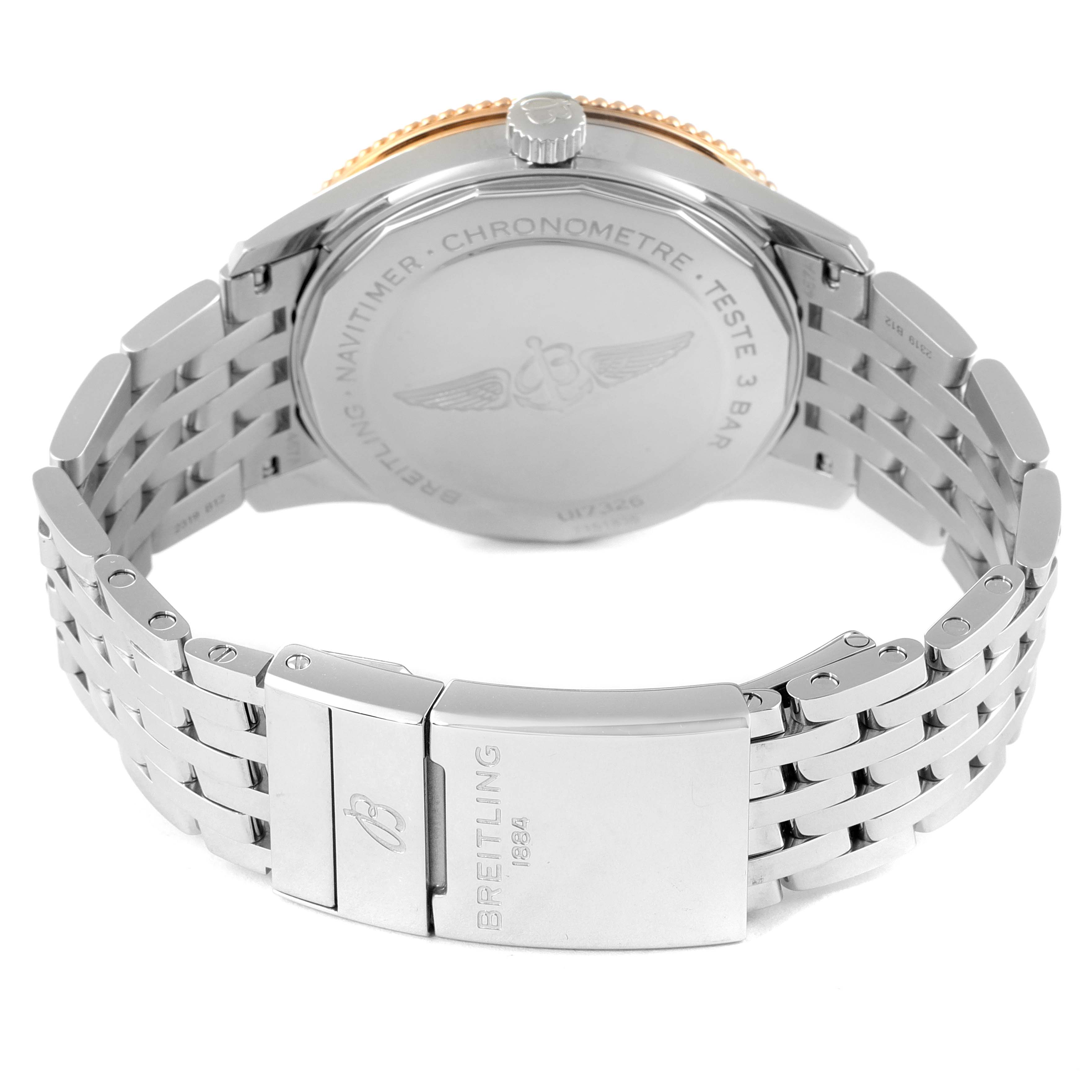 The image shows the rear view of the Breitling Navitimer U17326 Men's Steel and Gold (two tone) Silver Dial U17326 Men's Steel and Gold (two tone) Silver Dial watch, focusing on its closed stainless steel bracelet and engraved case back.