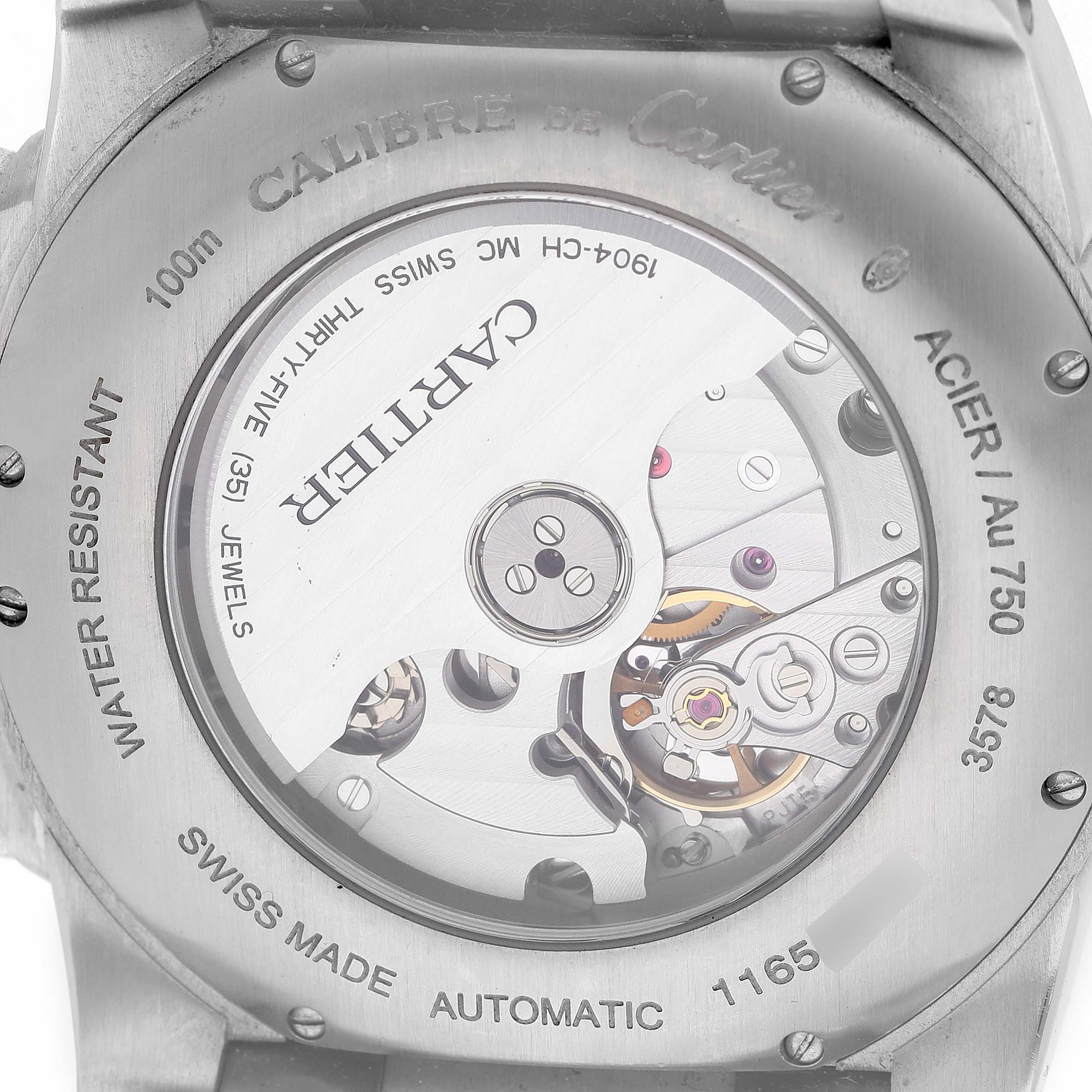 The image shows the back of a Calibre de Cartier watch, highlighting its automatic movement and engraved details.