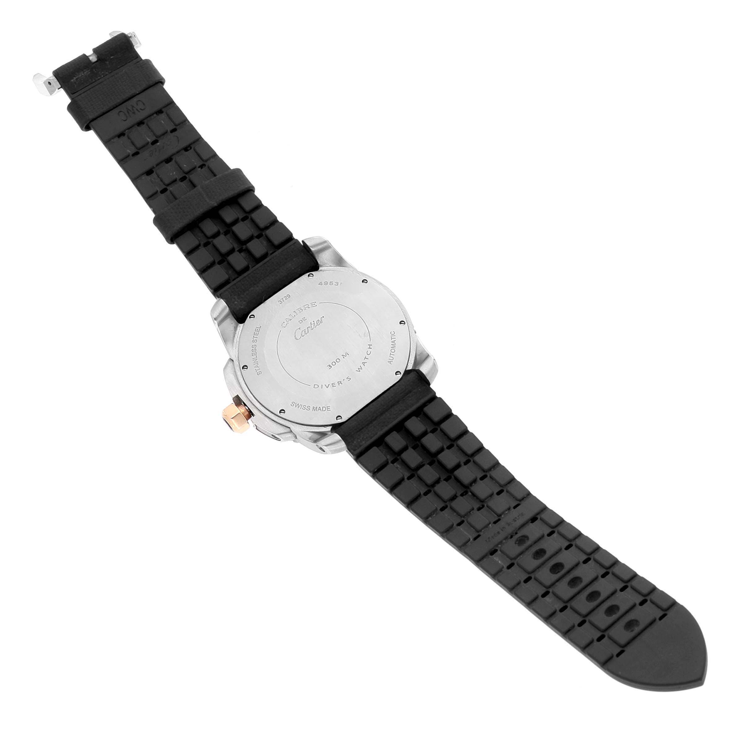 The image shows the back case and black rubber strap of a Calibre de Cartier watch by Cartier from a top-down angle.