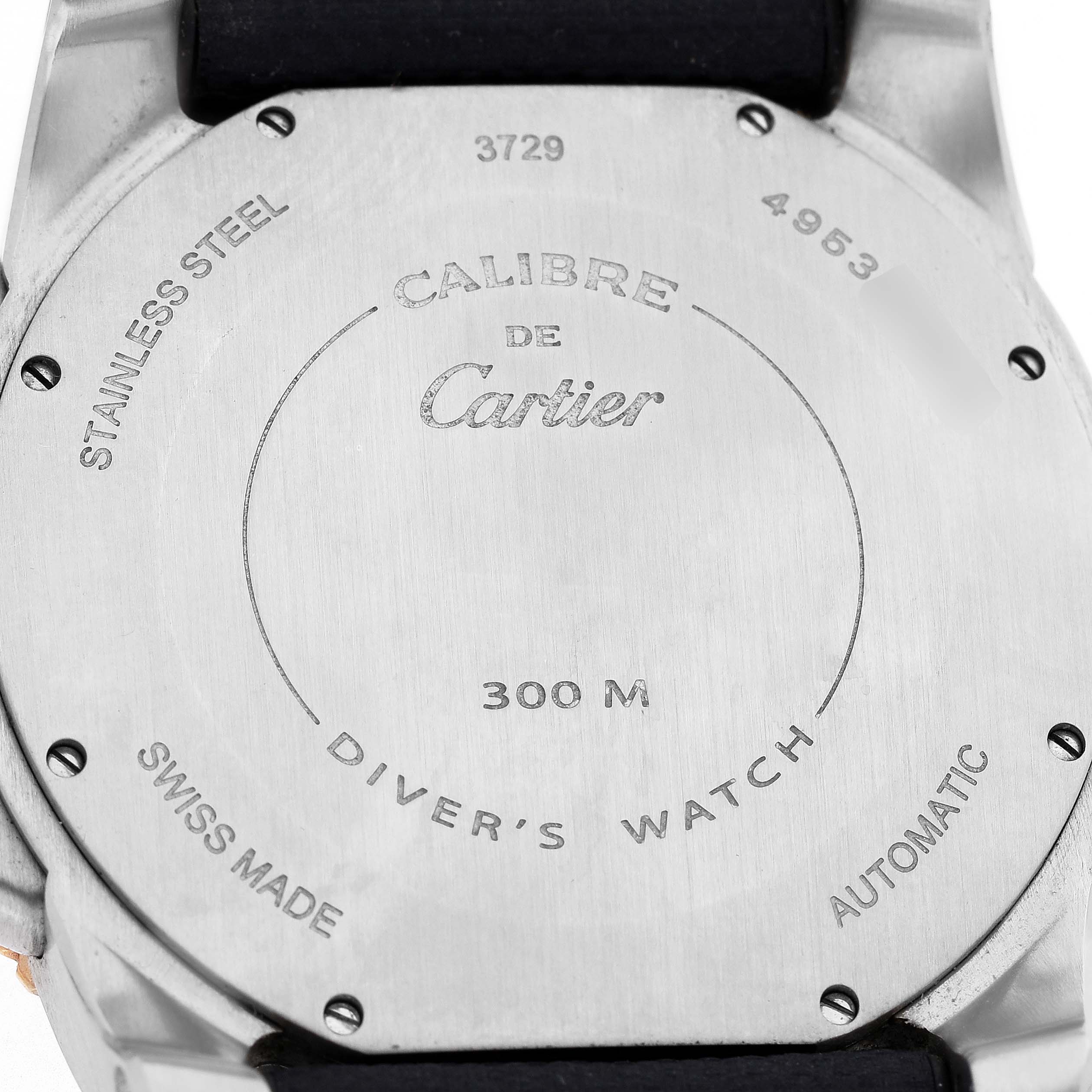 The image shows the back of a Calibre de Cartier watch, displaying engravings and specifications.