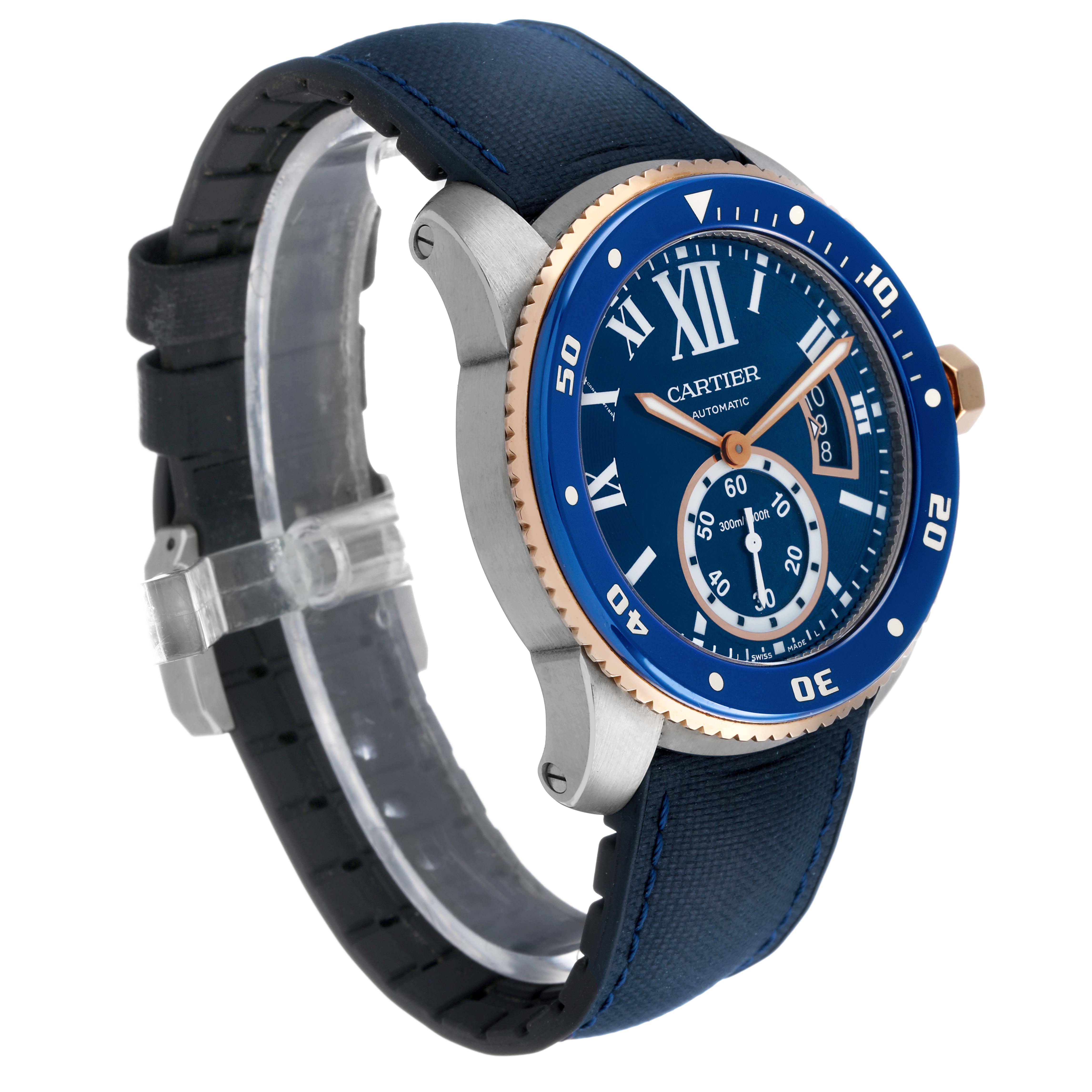 The Calibre de Cartier watch is shown at a three-quarter angle highlighting the blue dial, bezel, and strap.