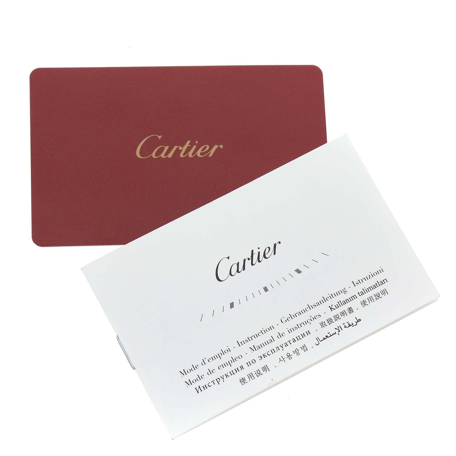 This image shows the instruction manual and card for the Drive de Cartier watch by Cartier, angled and slightly overlapping.