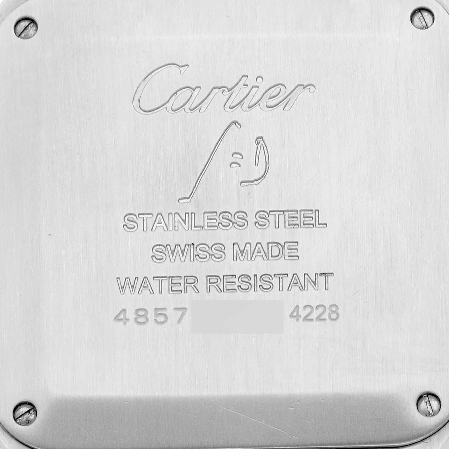 The image shows the case back of a Santos Dumont model by Cartier, highlighting its inscriptions and screws.