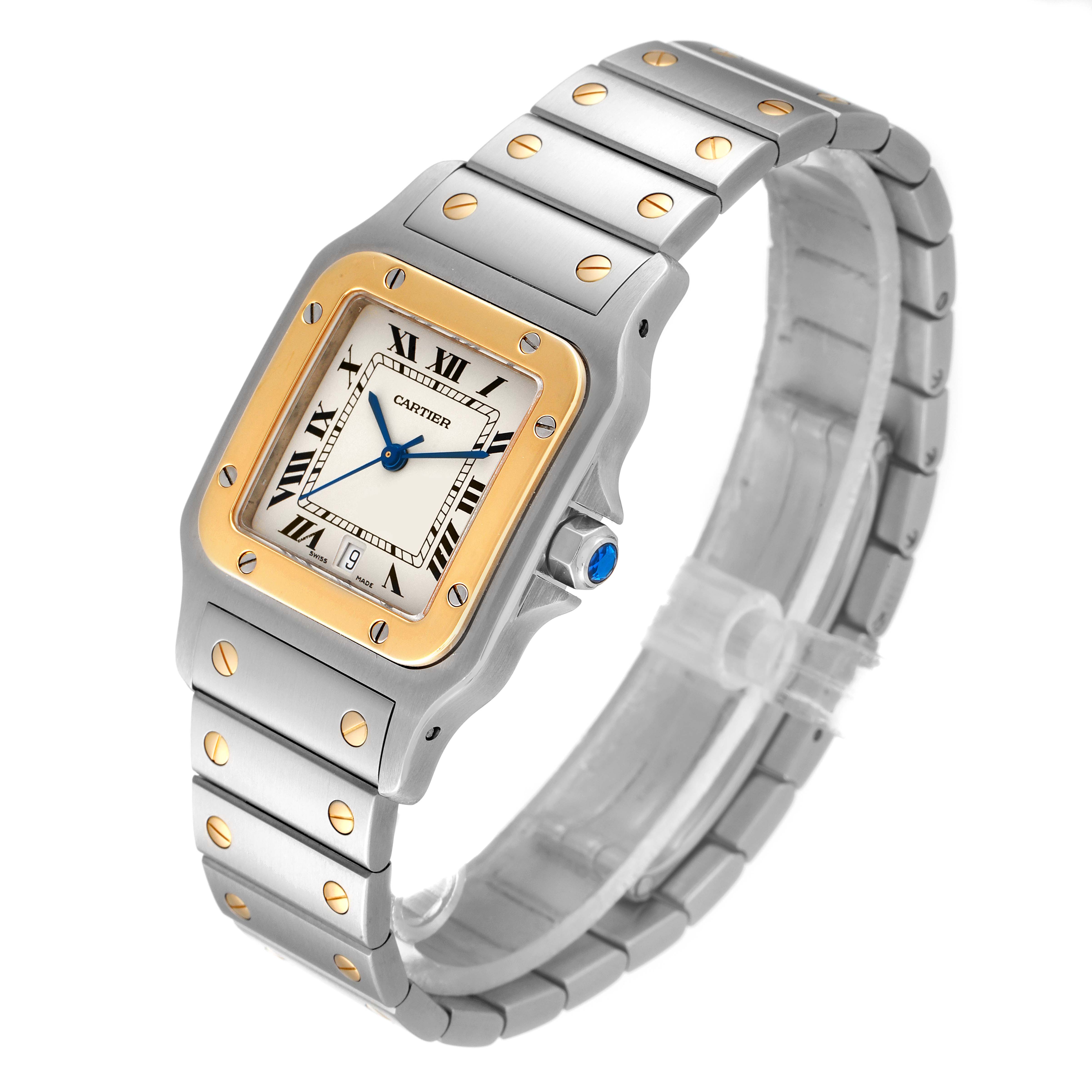 The Cartier Santos W20011C4 Men
s Steel and Gold (two tone) Silver Dial W20011C4 Men
s Steel and Gold (two tone) Silver Dial watch is shown from an oblique angle highlighting its face, bezel, and metal bracelet with screw details.