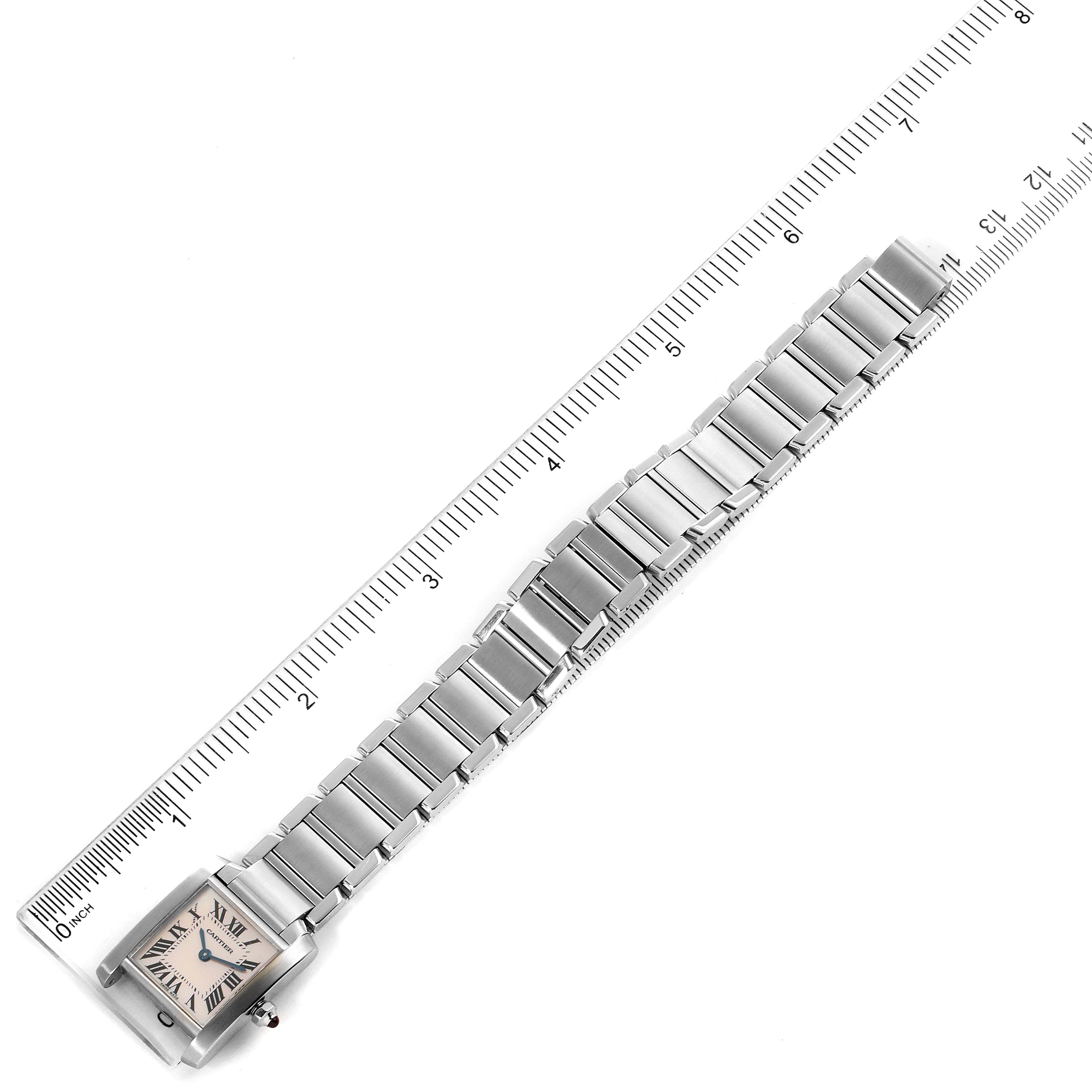 The image shows a top-down view of a Cartier Tank Francaise W51028Q3 Women's Stainless Steel Mother of Pearl Dial W51028Q3 Women's Stainless Steel Mother of Pearl Dial watch laid next to a ruler.