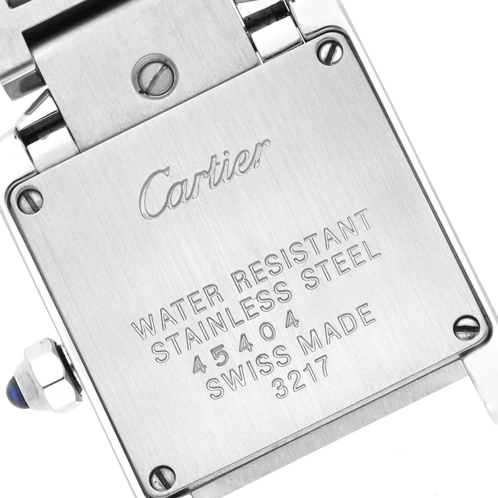 The image shows the back case of a Cartier Tank Francaise W4TA0008 Women's Stainless Steel Silver Dial W4TA0008 Women's Stainless Steel Silver Dial watch, including engravings and part of the bracelet.