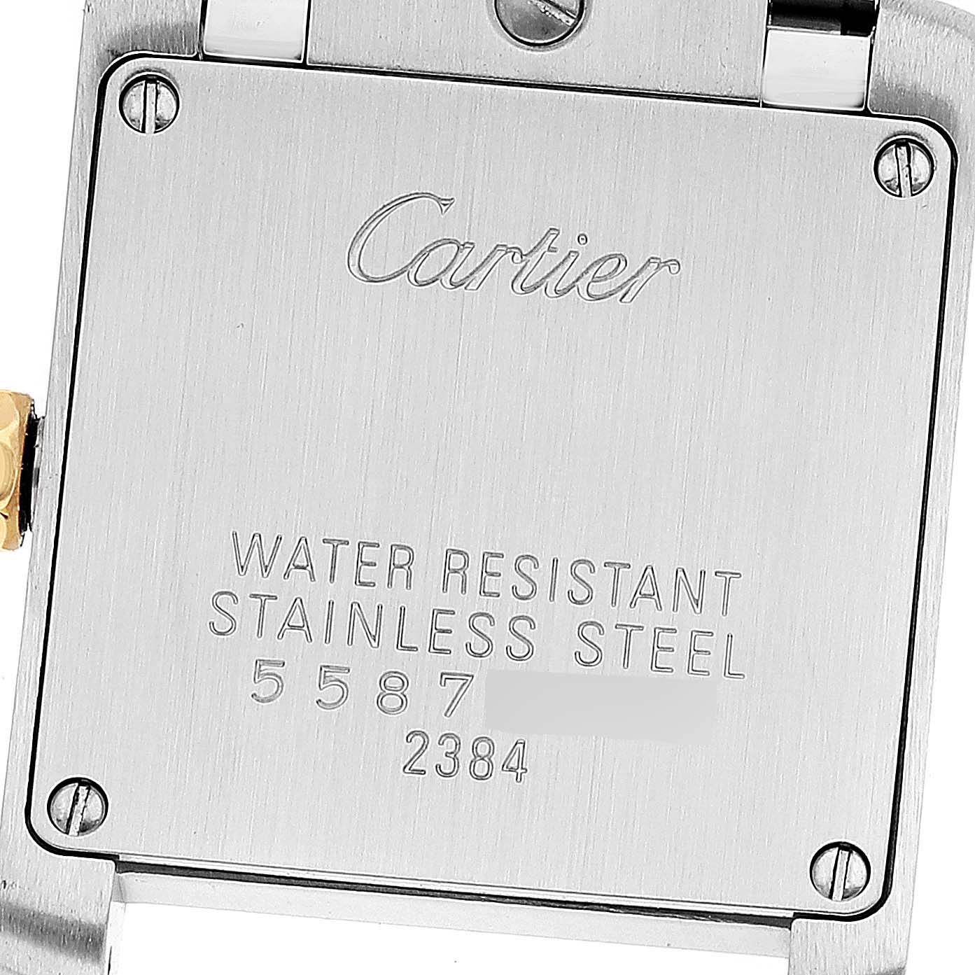 The image shows the back case of the Cartier Tank Française watch, highlighting its stainless steel construction and serial numbers.