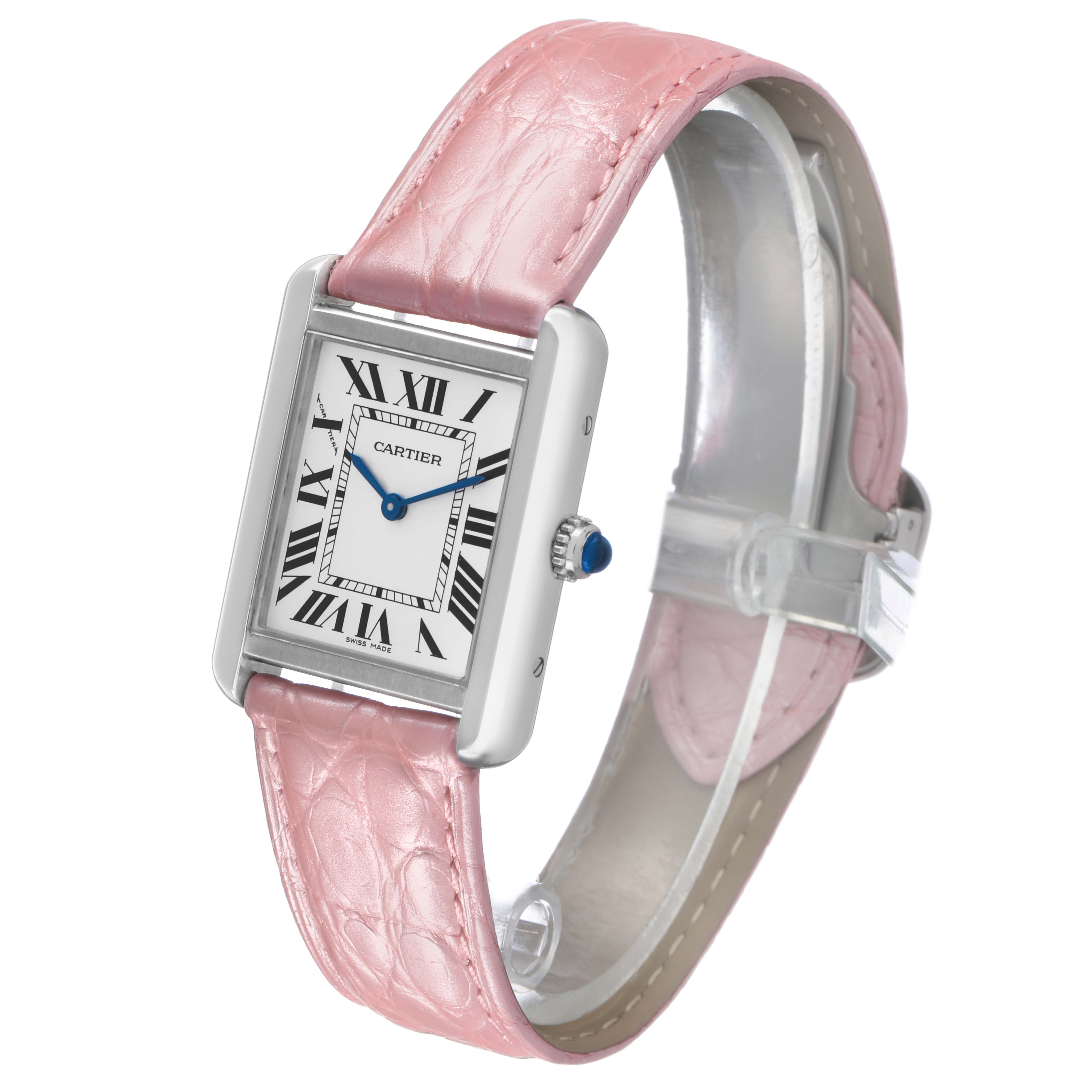 The Cartier Tank Solo WSTA0030 Women's Stainless Steel Silver Dial watch is shown at a three-quarter angle, displaying its face, pink strap, and crown with a blue cabochon.