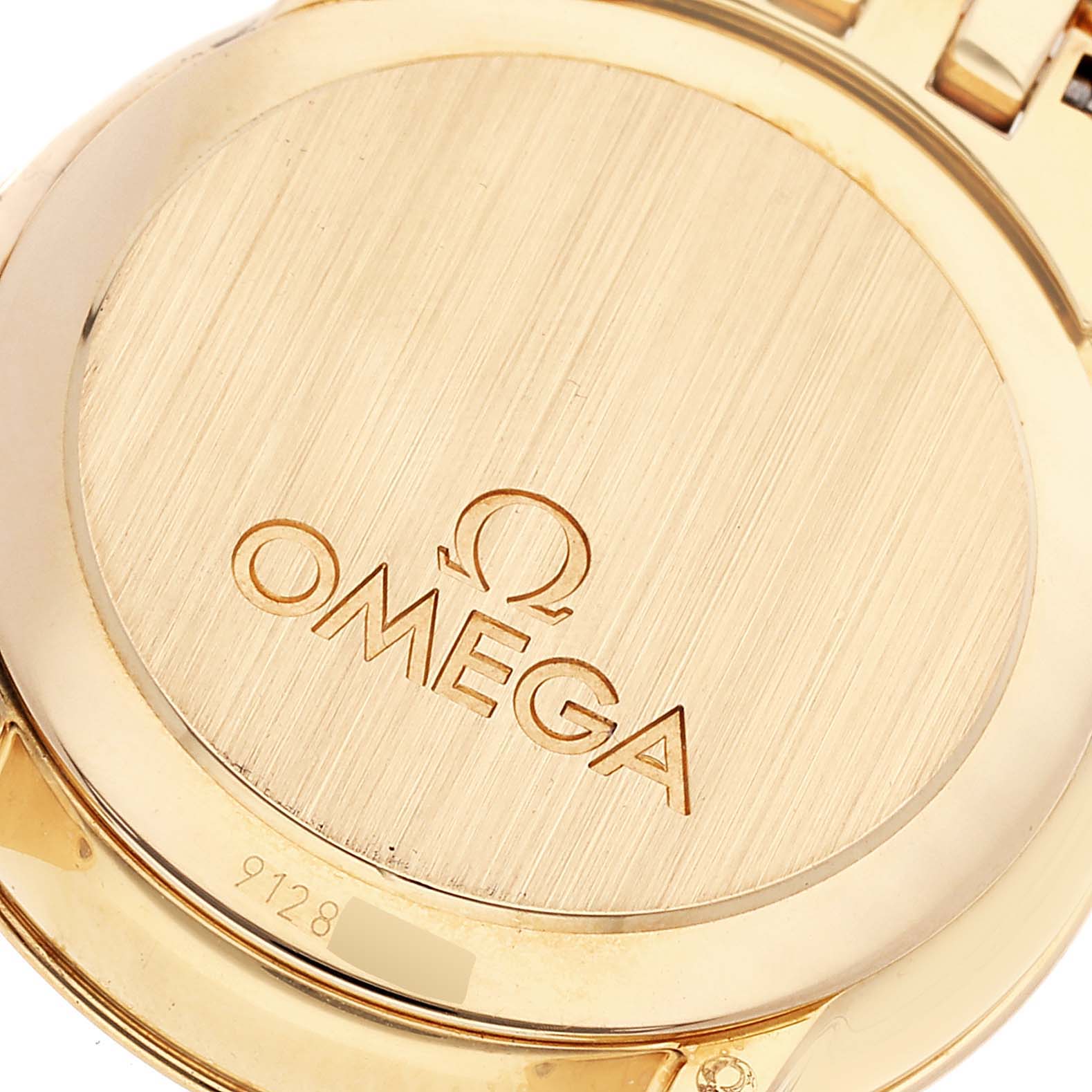 This is a close-up view of the DeVille Prestige Yellow Gold Diamond Ladies Watch 413.55.27.60.55.001 model by Omega 413.55.27.60.55.001 Women's Yellow Gold Mother of Pearl Dial 413.55.27.60.55.001 Women's Yellow Gold Mother of Pearl Dial, showing the back case.