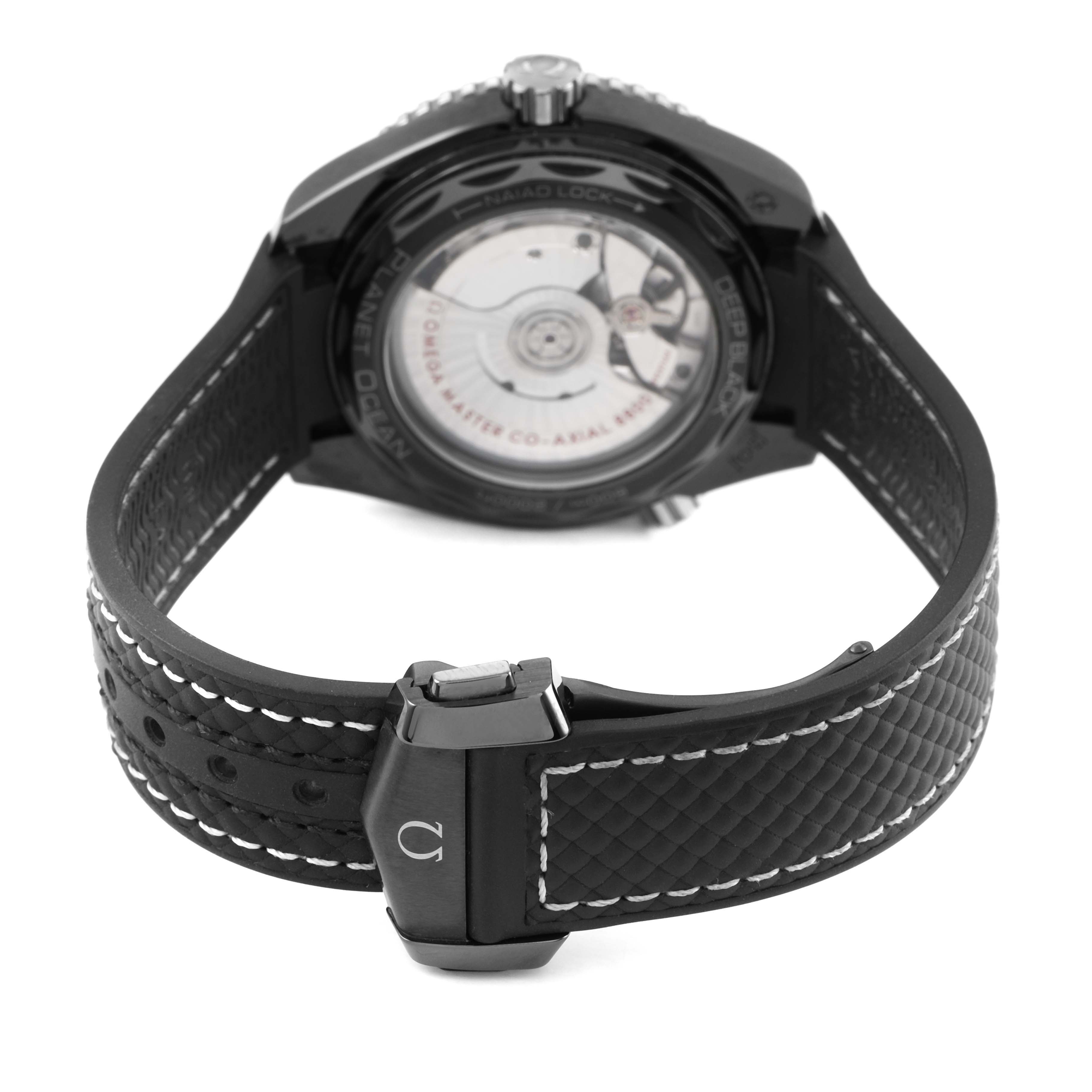 The image shows the back case and strap of the Omega Planet Ocean 215.92.40.20.01.001 Men's Ceramic Black Dial watch, highlighting the movement and clasp.
