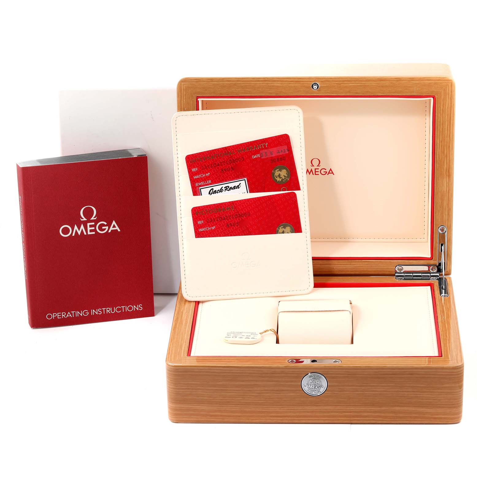 This image shows the accessories for an Omega Aqua Terra 231.10.42.21.02.003 Men's Stainless Steel Silver Dial 231.10.42.21.02.003 Men's Stainless Steel Silver Dial watch, including a wooden box, warranty cards, and operating instructions.