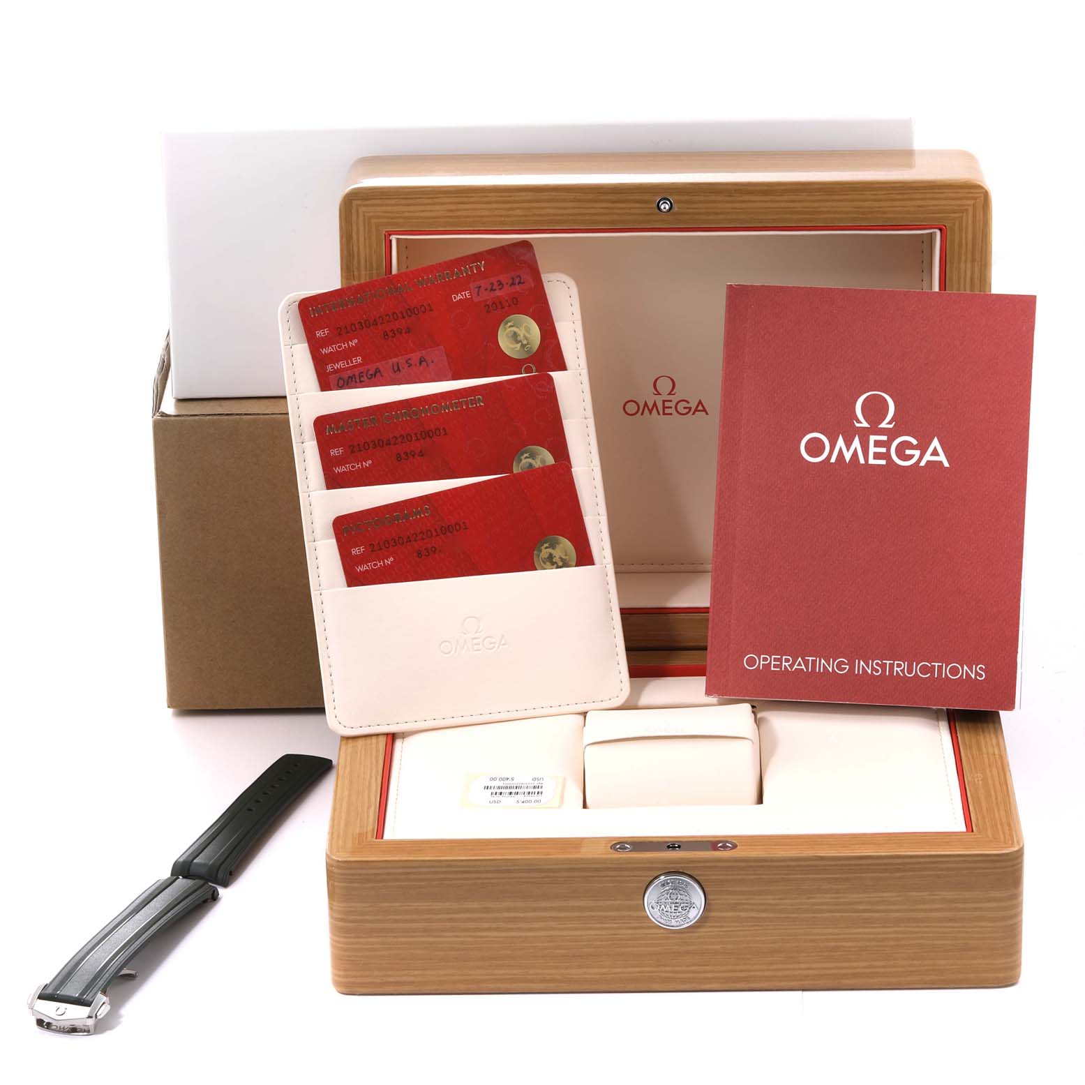 The image shows the Omega Seamaster 210.30.42.20.10.001 Men's Stainless Steel Green Dial 210.30.42.20.10.001 Men's Stainless Steel Green Dial watch packaging, including instruction manuals, warranty cards, a strap, and the storage box.