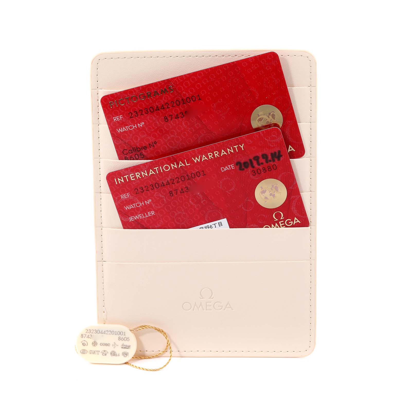 The image shows Omega Planet Ocean 232.30.44.22.01.001 Men
s Stainless Steel Black Dial 232.30.44.22.01.001 Men
s Stainless Steel Black Dial warranty and pictogram cards in a holder with a tag.