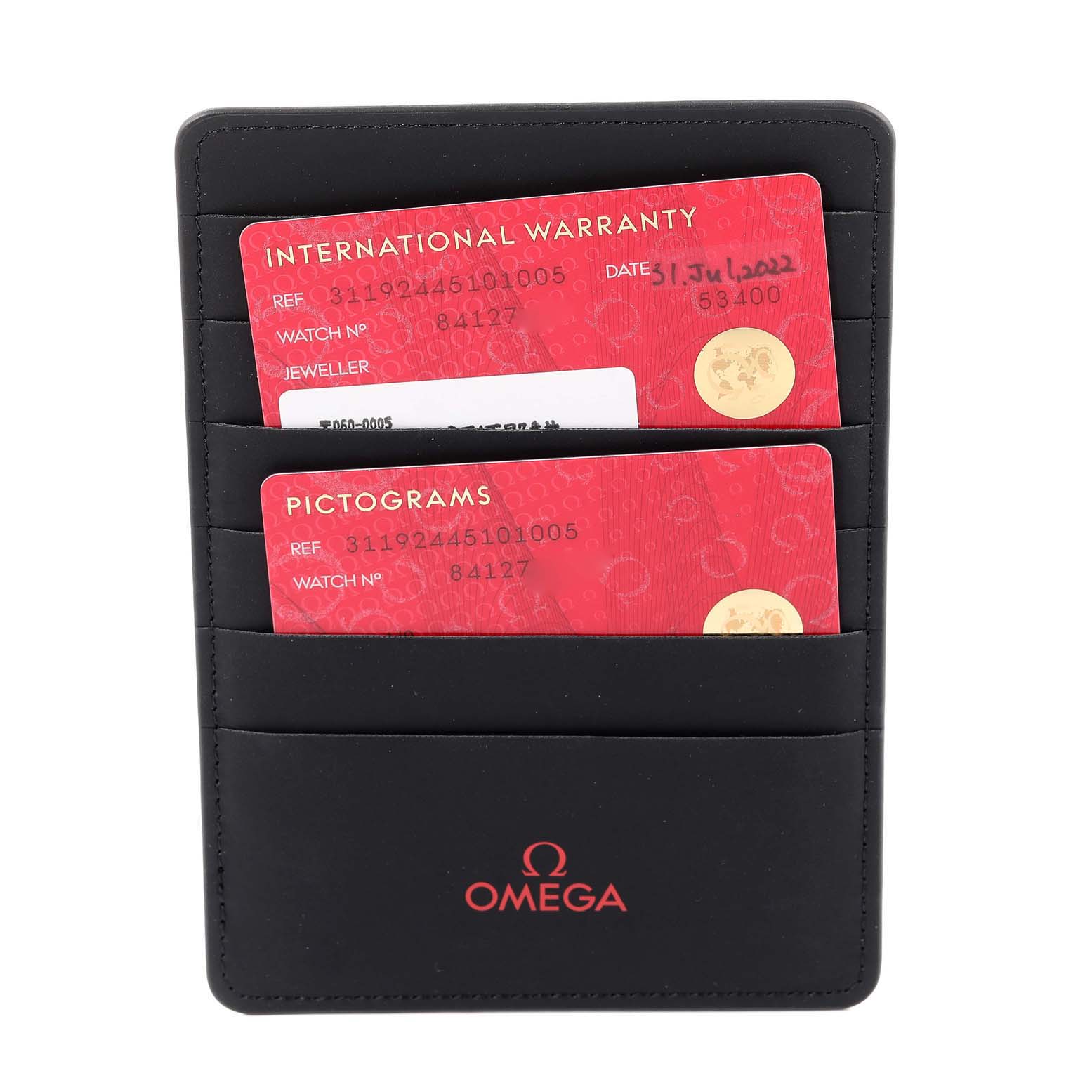 The image shows International Warranty and Pictograms cards for the Omega Speedmaster 311.92.44.51.01.005 Men's Stainless Steel Black Dial 311.92.44.51.01.005 Men's Stainless Steel Black Dial, placed inside a black Omega cardholder.