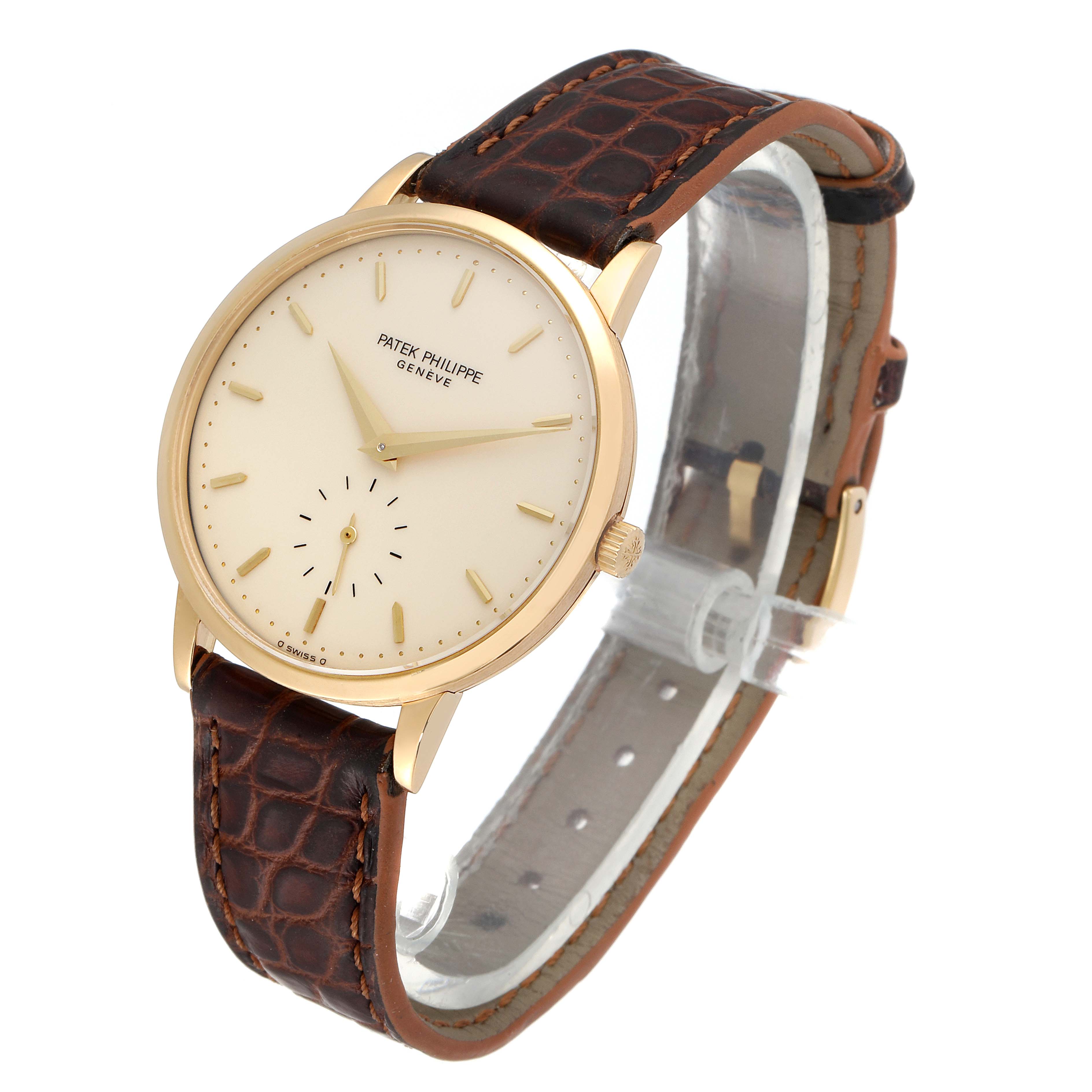 This image shows a side angle of a Patek Philippe Calatrava 3893J Men's Yellow Gold Beige Dial 3893J Men's Yellow Gold Beige Dial watch, featuring its face, crown, and leather strap.